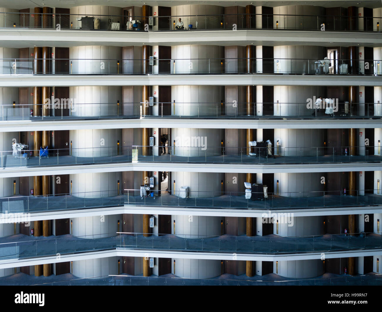 L'équipe de nettoyage d'un grand hôtel d'affaires est de nettoyer le sol de l'hôtel et les chambres. De nombreuses chambres sur plusieurs étages visibles. Banque D'Images