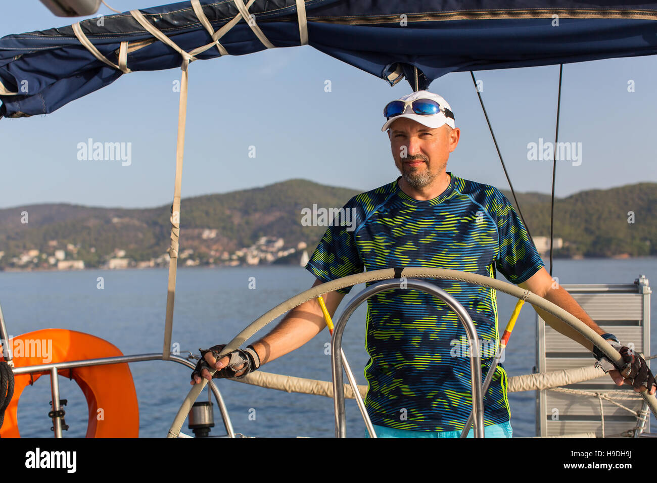 La roue de l'homme oriente skipper yacht à voile. Location, vacances, voyage. Banque D'Images