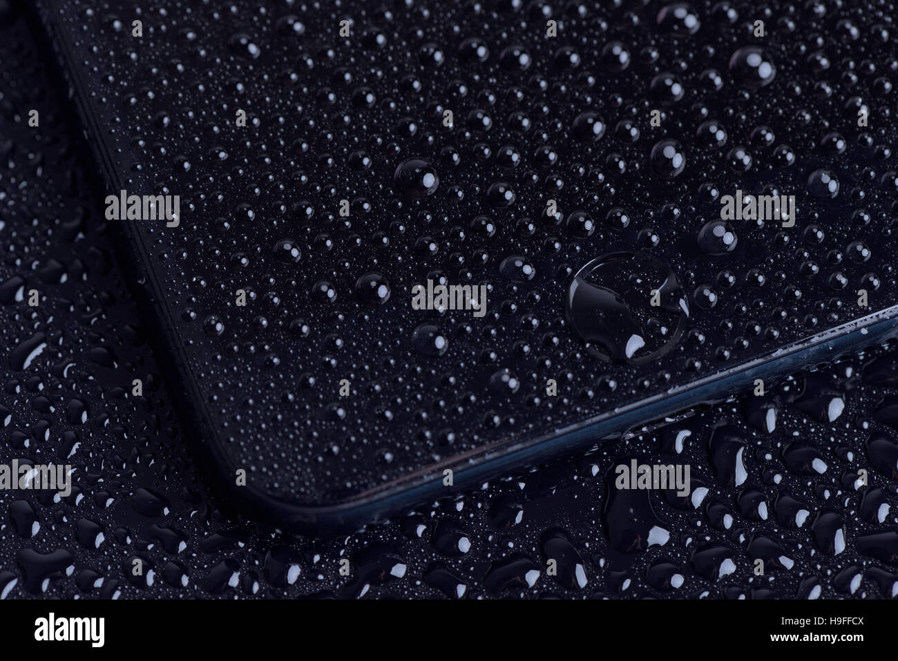 GALATI, Roumanie - 22 NOVEMBRE 2016 : l'Iphone 7 Plus Accueil bouton avec gouttes d'eau. Test du téléphone dans un magasin local. Banque D'Images