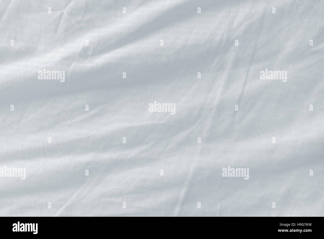 Draps de lit utilisé la texture, nettoyer la surface du matériau en coton froissé blanc Banque D'Images