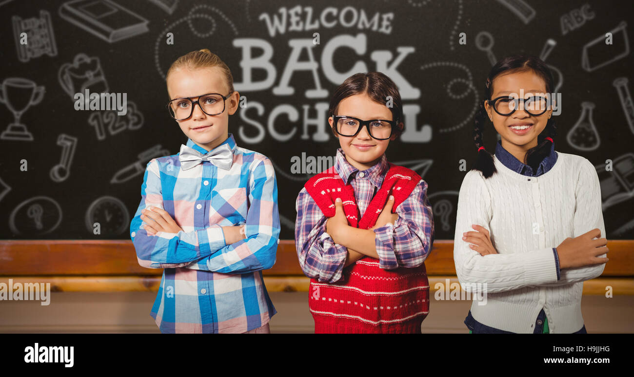Image composite de trois enfants de l'école avec les bras croisés Banque D'Images