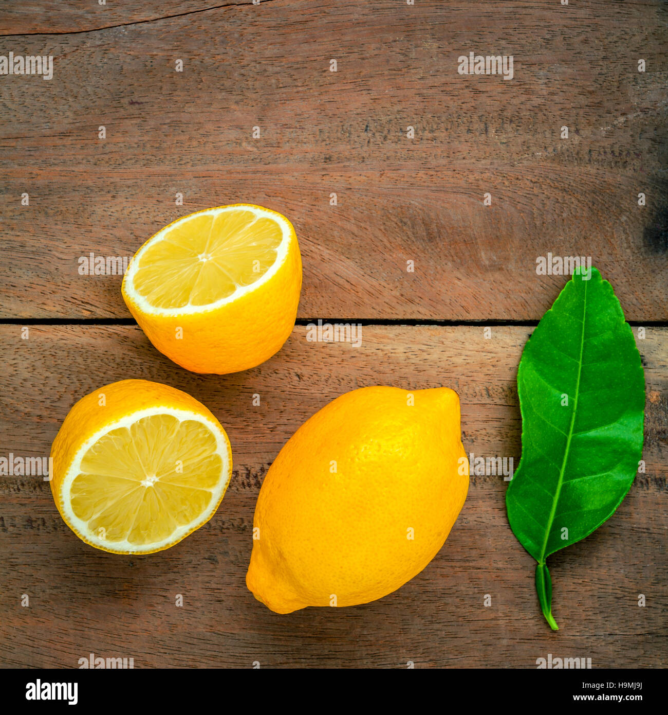 Citrons frais et citrons feuilles sur fond de bois rustique. Fre Banque D'Images