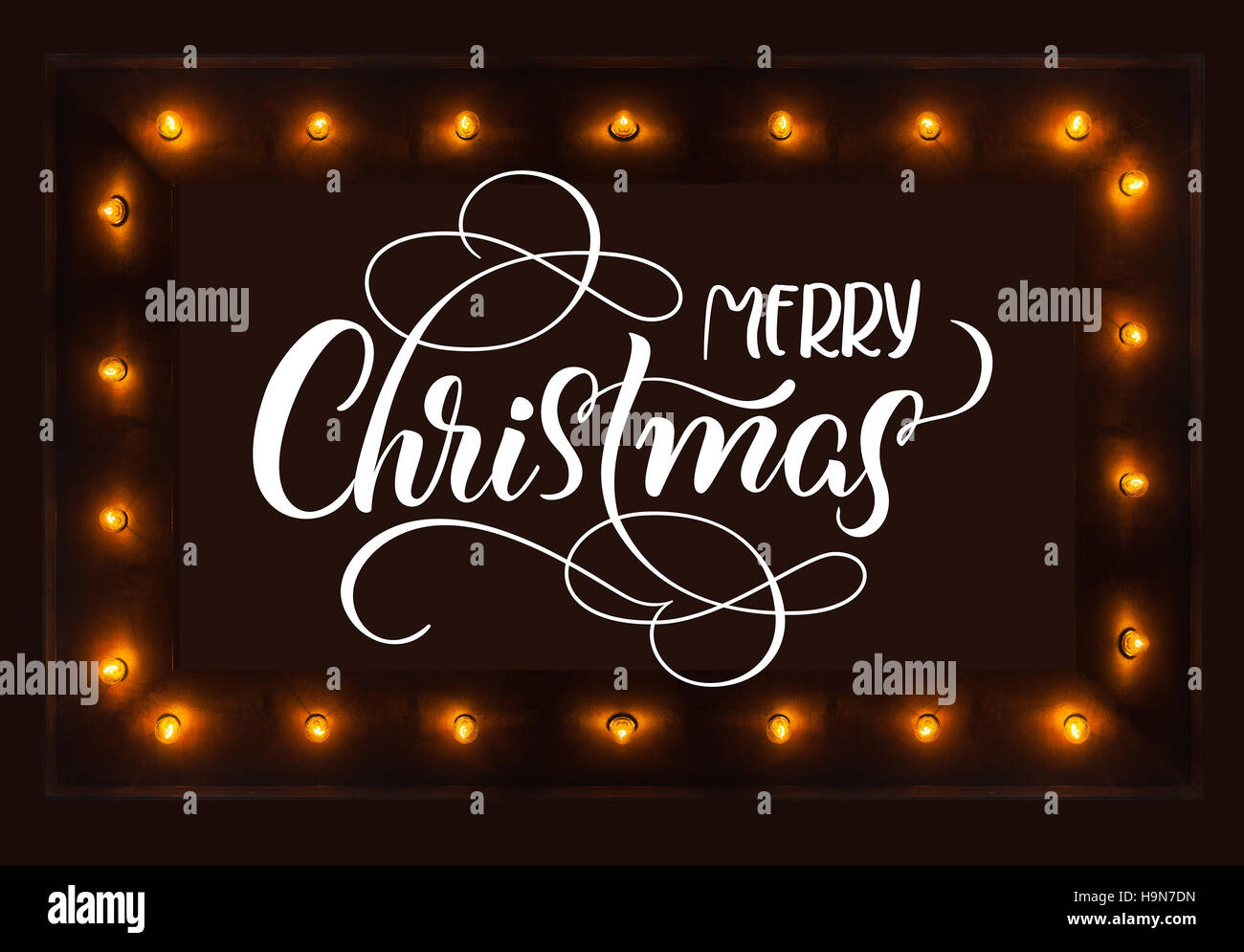 Fond sombre avec les ampoules et joyeux Noël texte. Lettrage calligraphie Banque D'Images