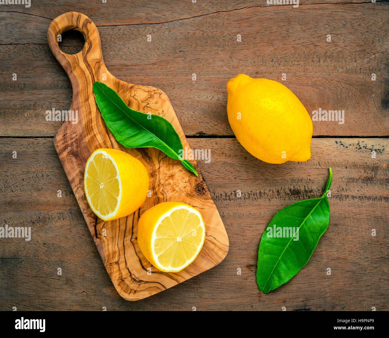 Citrons frais et citrons feuilles sur fond de bois rustique. Fre Banque D'Images