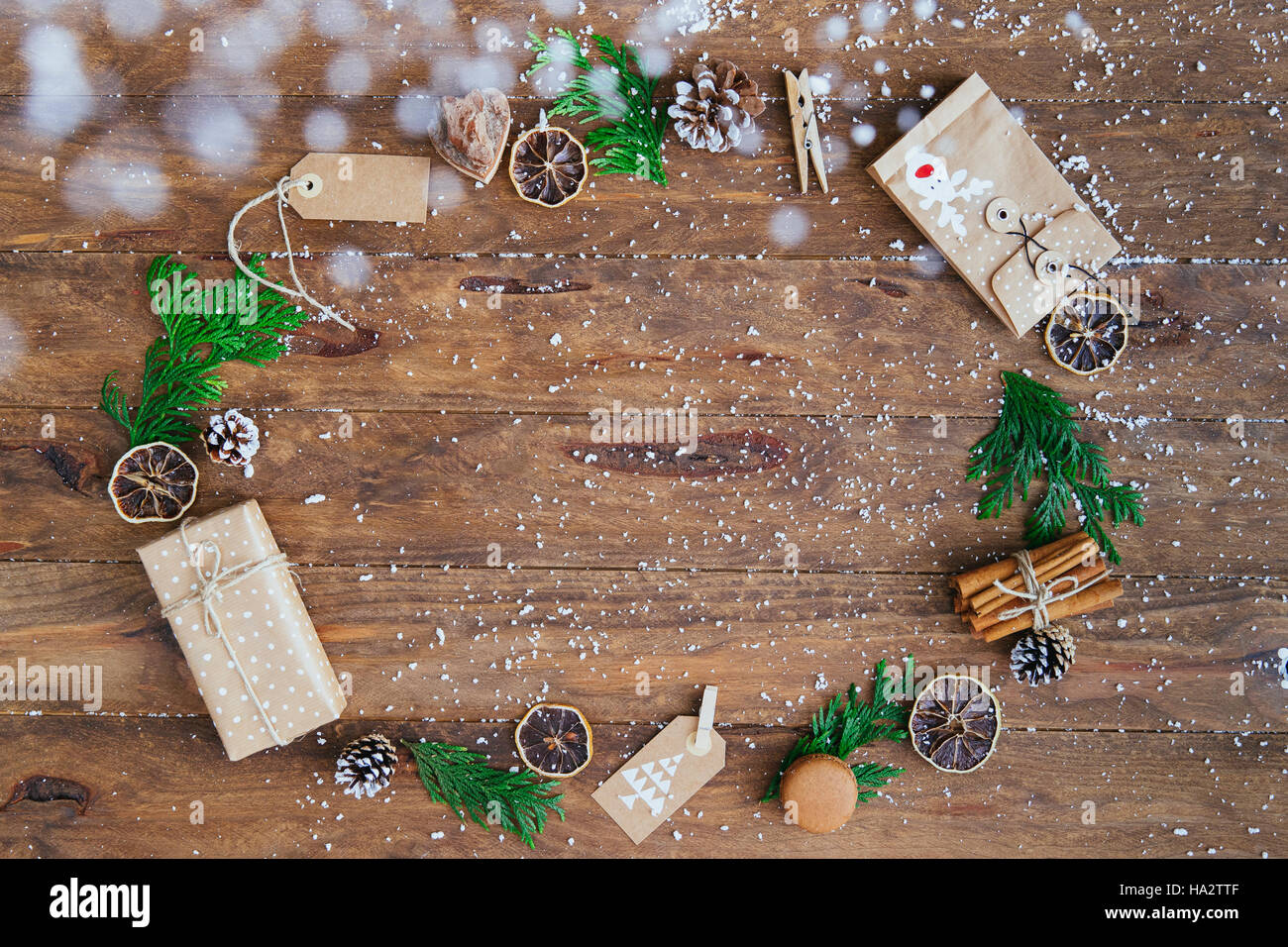 Cadeaux de Noël, des étiquettes, des pommes de pin, feuilles de pins, des bâtons de cannelle et les rondelles d'orange dans un cercle Banque D'Images