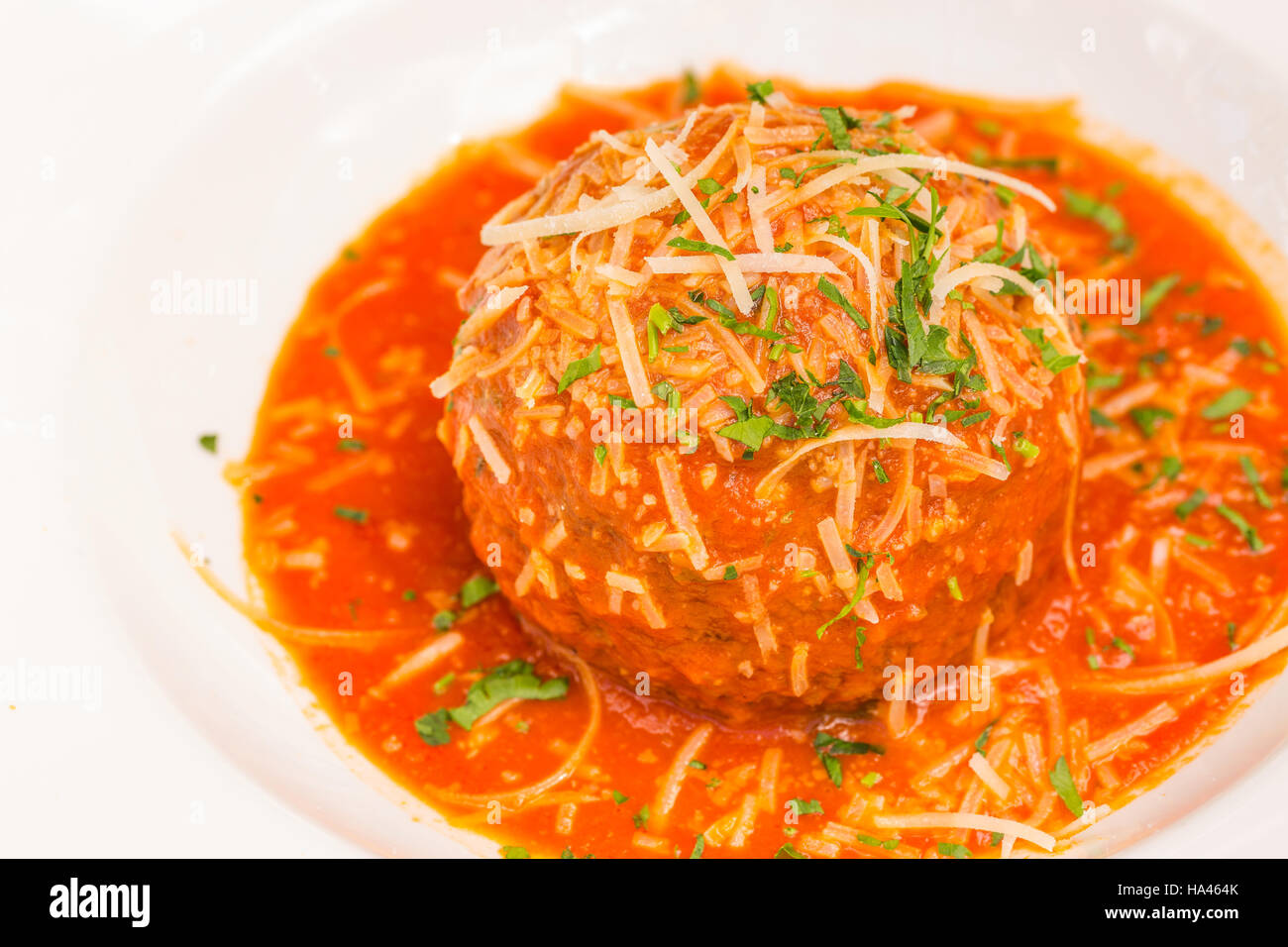 Un très grand Italian meatball baigné dans de riches pomodoro, garni de persil et de parmesan Banque D'Images