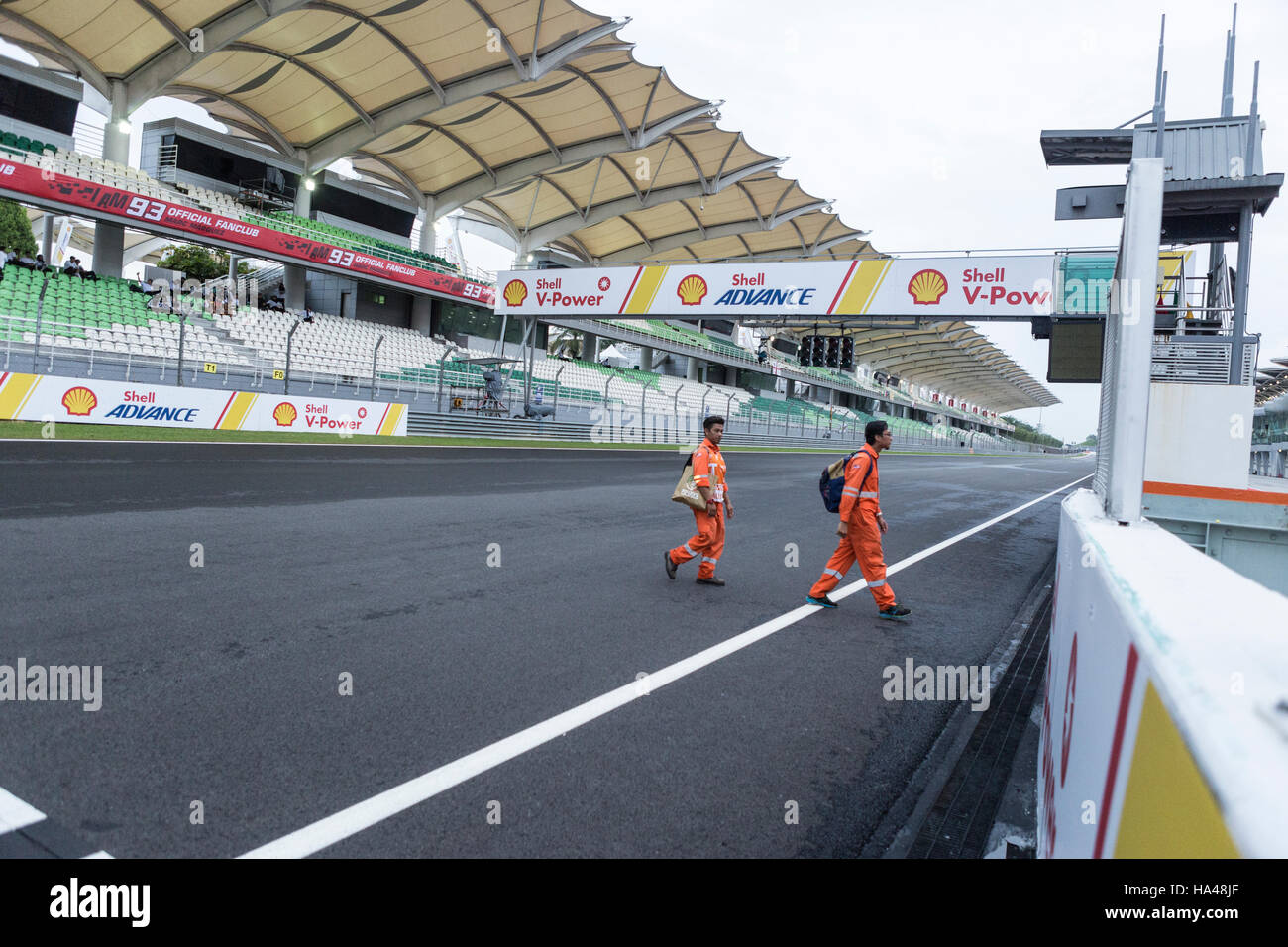 Marshalls traverser la piste après le Moto GP de Malaisie à Sepang, Malaisie Banque D'Images