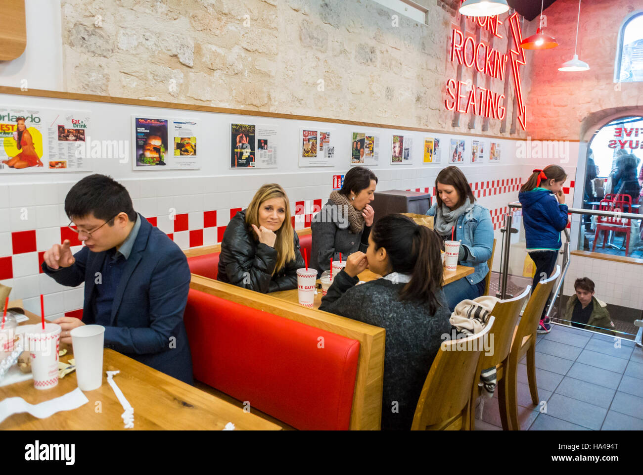 Paris, France, Français, famille, partage de repas au sein du Restaurant de restauration rapide américain, « Five Guys », Bercy, décoration intérieure 50s, famille de classe moyenne Banque D'Images