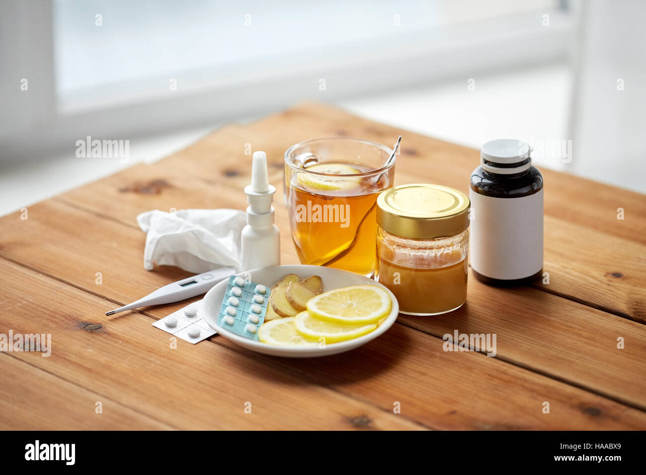 La drogue, thermomètre, le miel et une tasse de thé sur bois Banque D'Images