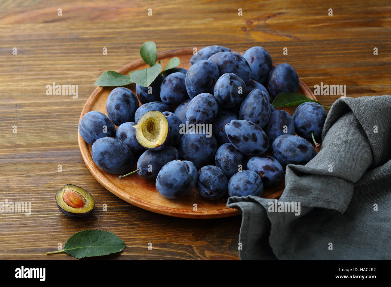 Pruneaux frais mûrs fruits sur platine, close-up Banque D'Images