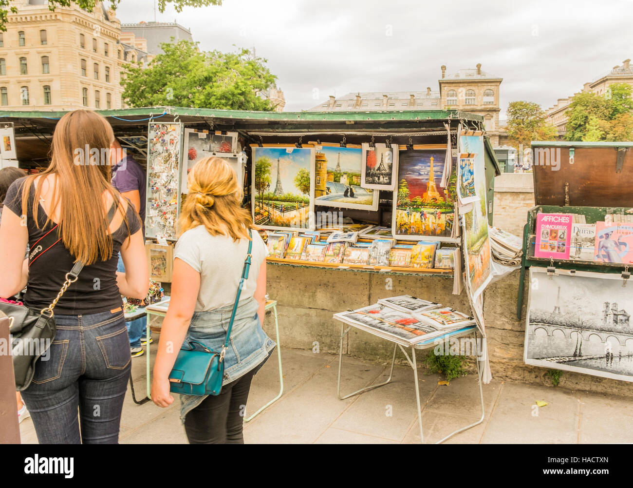 Les touristes de passage    traditionnels bouquiniste libraire caler sur les rives du fleuve la Seine Banque D'Images