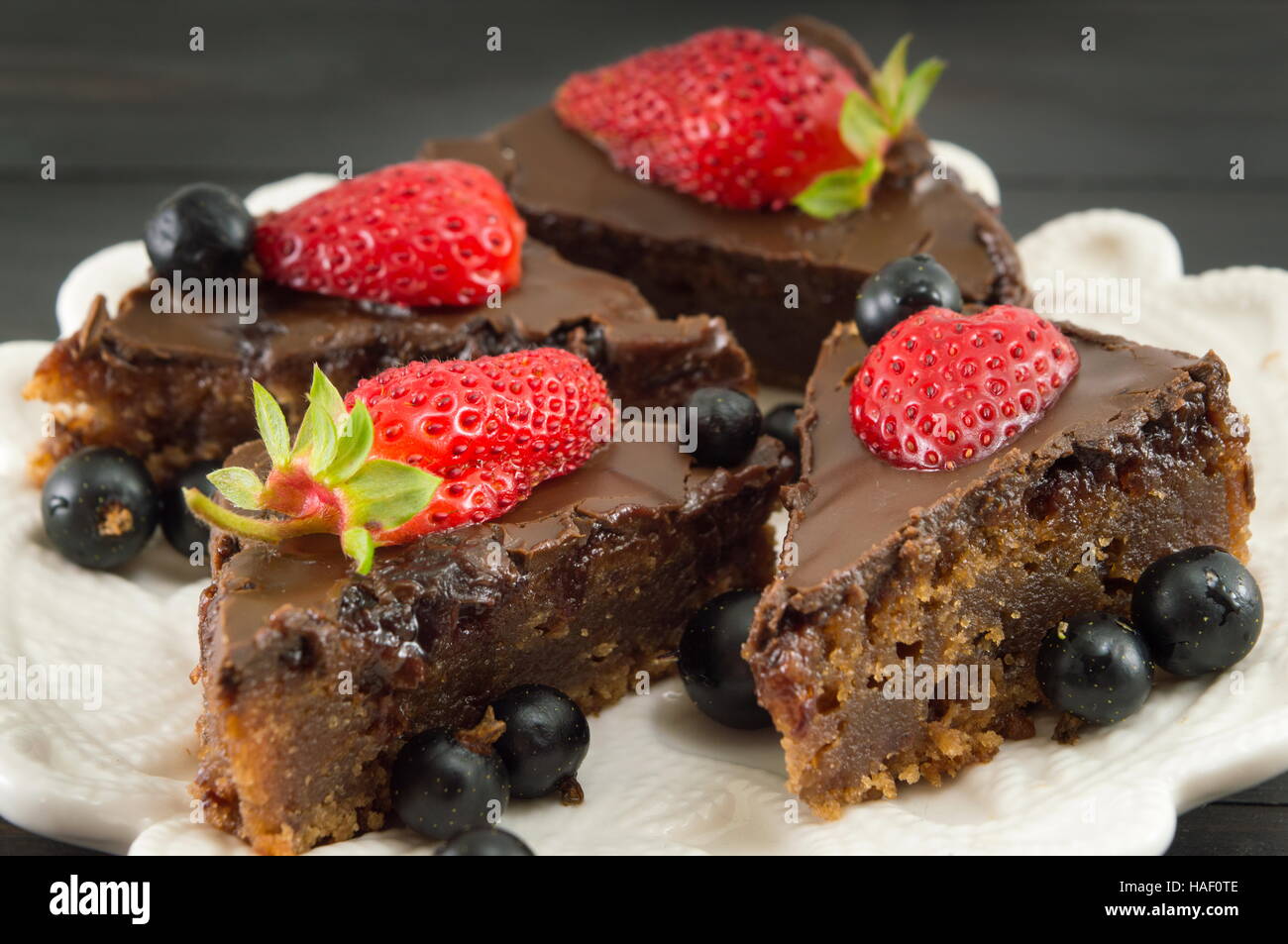 Tranches de gâteau au chocolat avec des fraises entières sur le dessus Banque D'Images