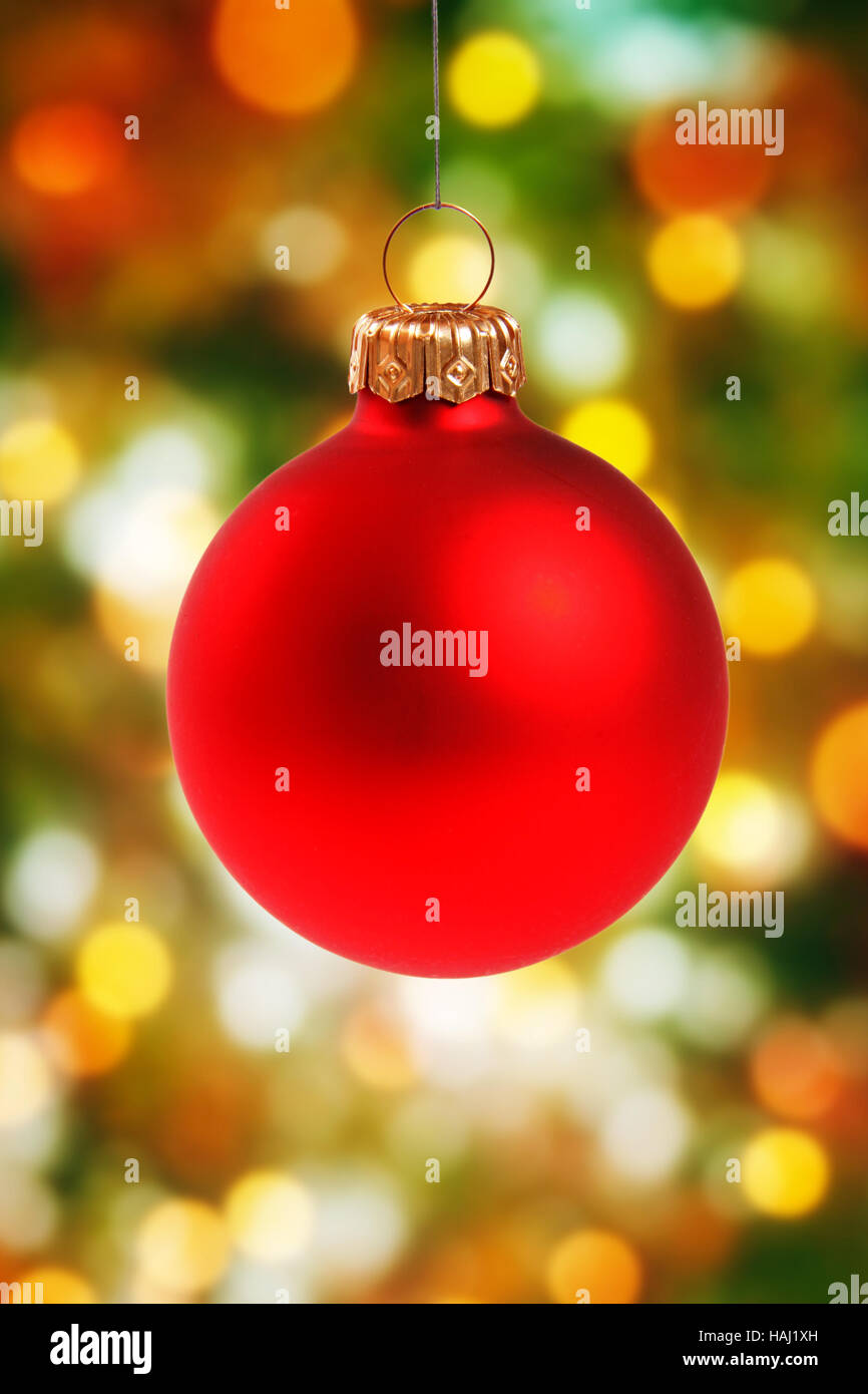 Boule de Noël rouge accroché sur l'arrière-plan flou coloré Banque D'Images