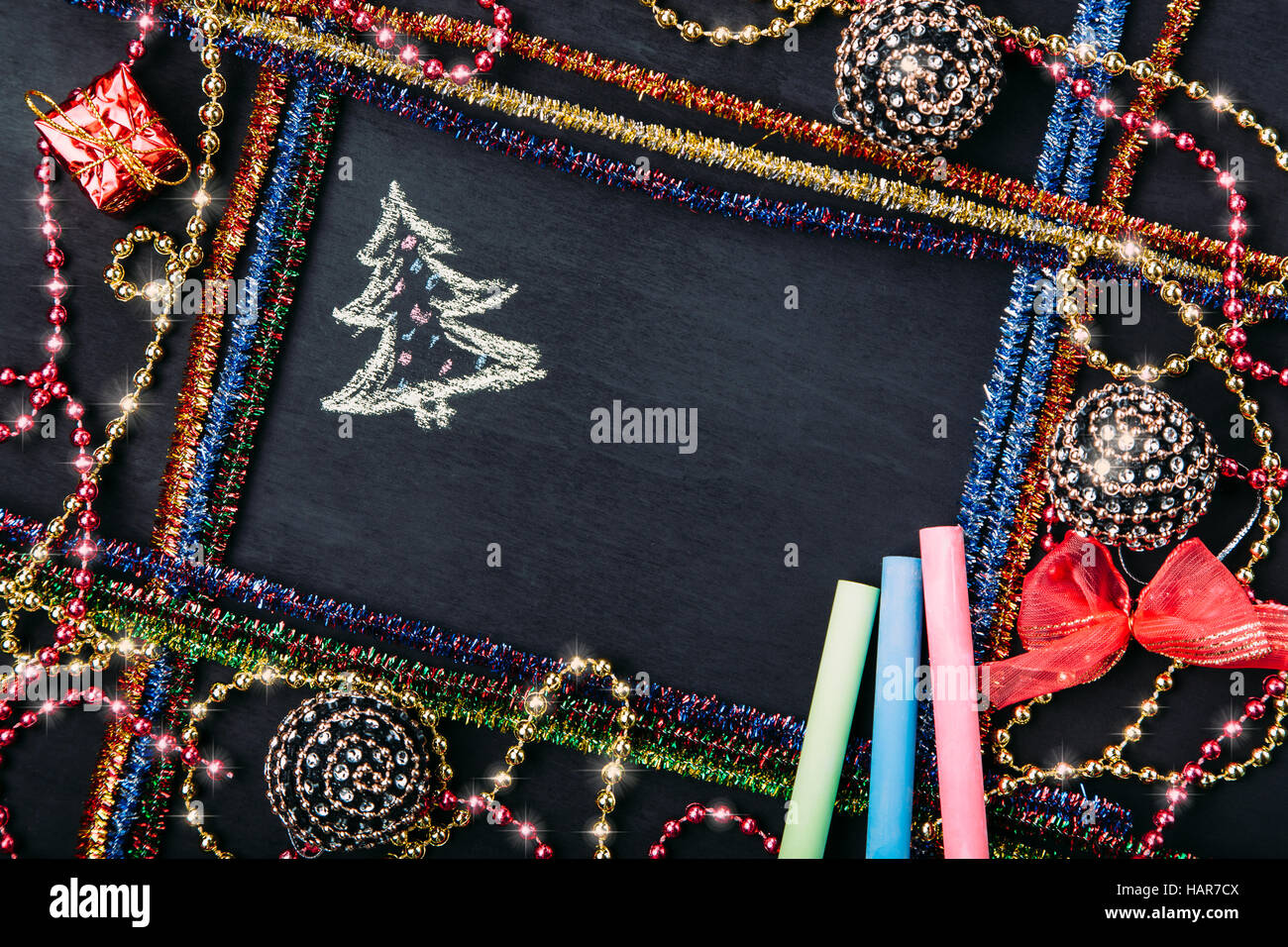 Boules de Noël et des décorations, des perles et noeud sur le tableau noir, vue du dessus, copy space Banque D'Images