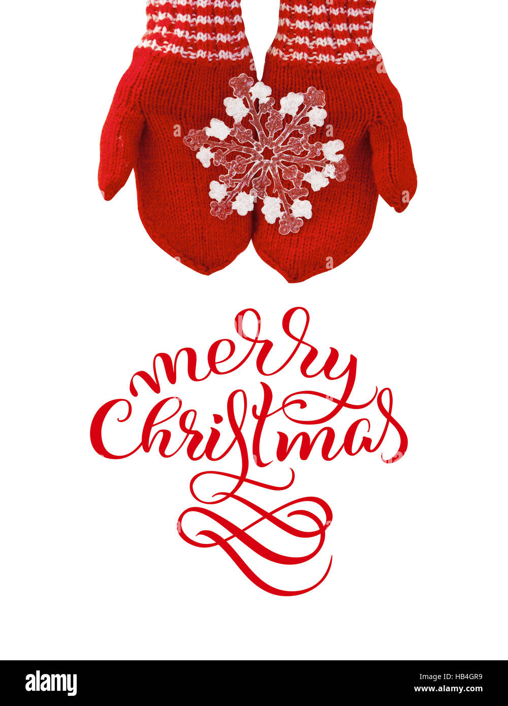 Les mitaines rouges dans les mains femme tenir un jouet flocon avec texte Joyeux Noël. Calligraphie lettrage Banque D'Images