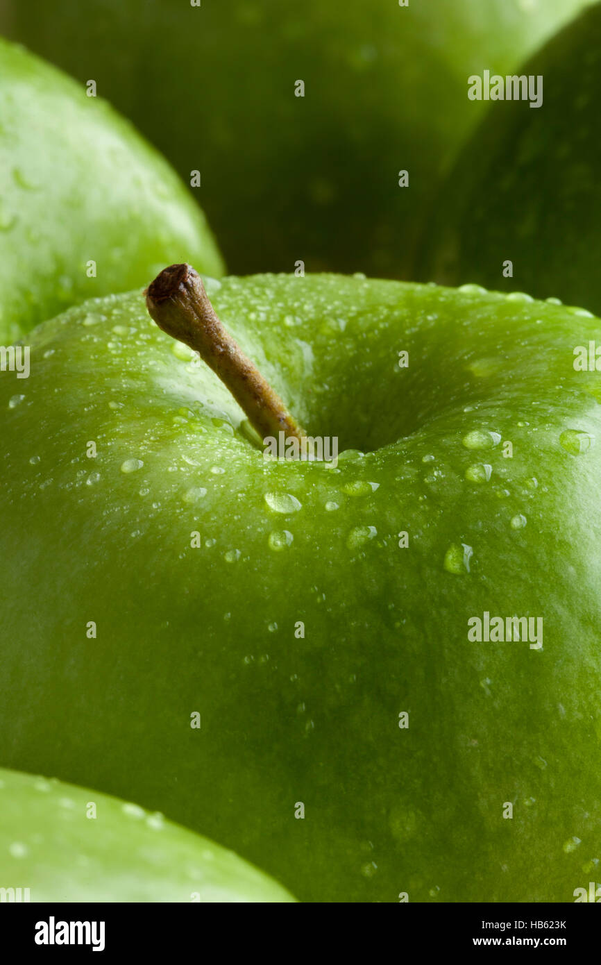 Pomme verte avec de l'eau gouttes close up Banque D'Images