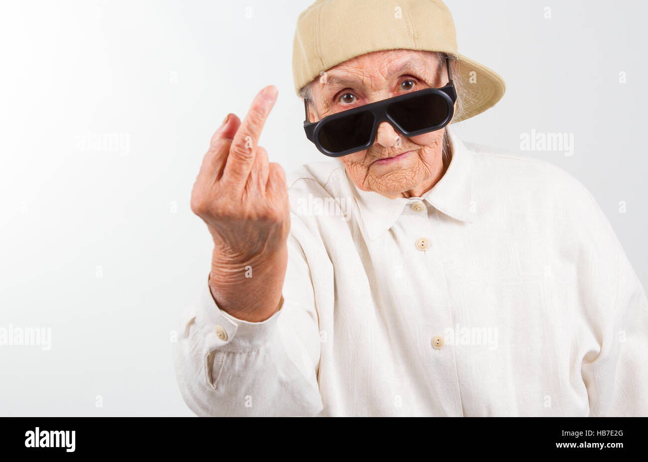 Funny Grandma's Boy portant des lunettes et casquette, qui montre son f- doigt , isolated on white Photo Stock - Alamy