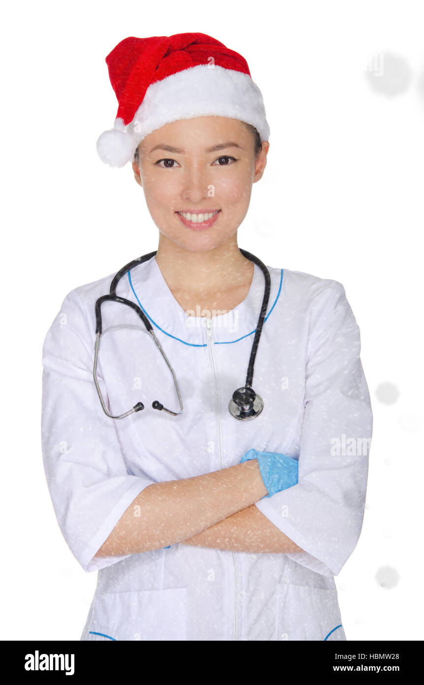 Médecin asiatique et Santa hat with snow Banque D'Images