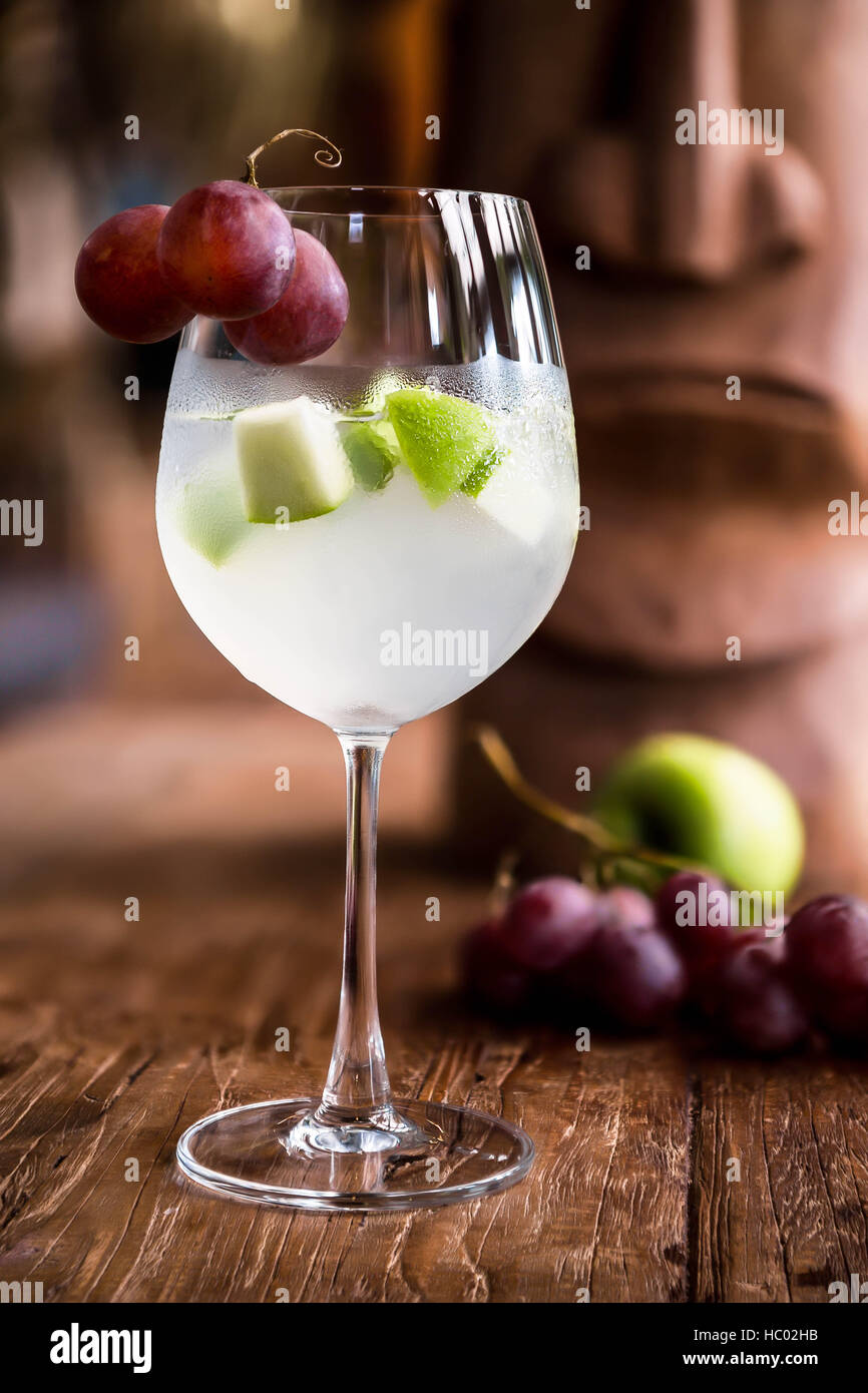 Cocktail Sangria blanche avec des raisins rouges, de pomme verte et de chardonnay. Banque D'Images