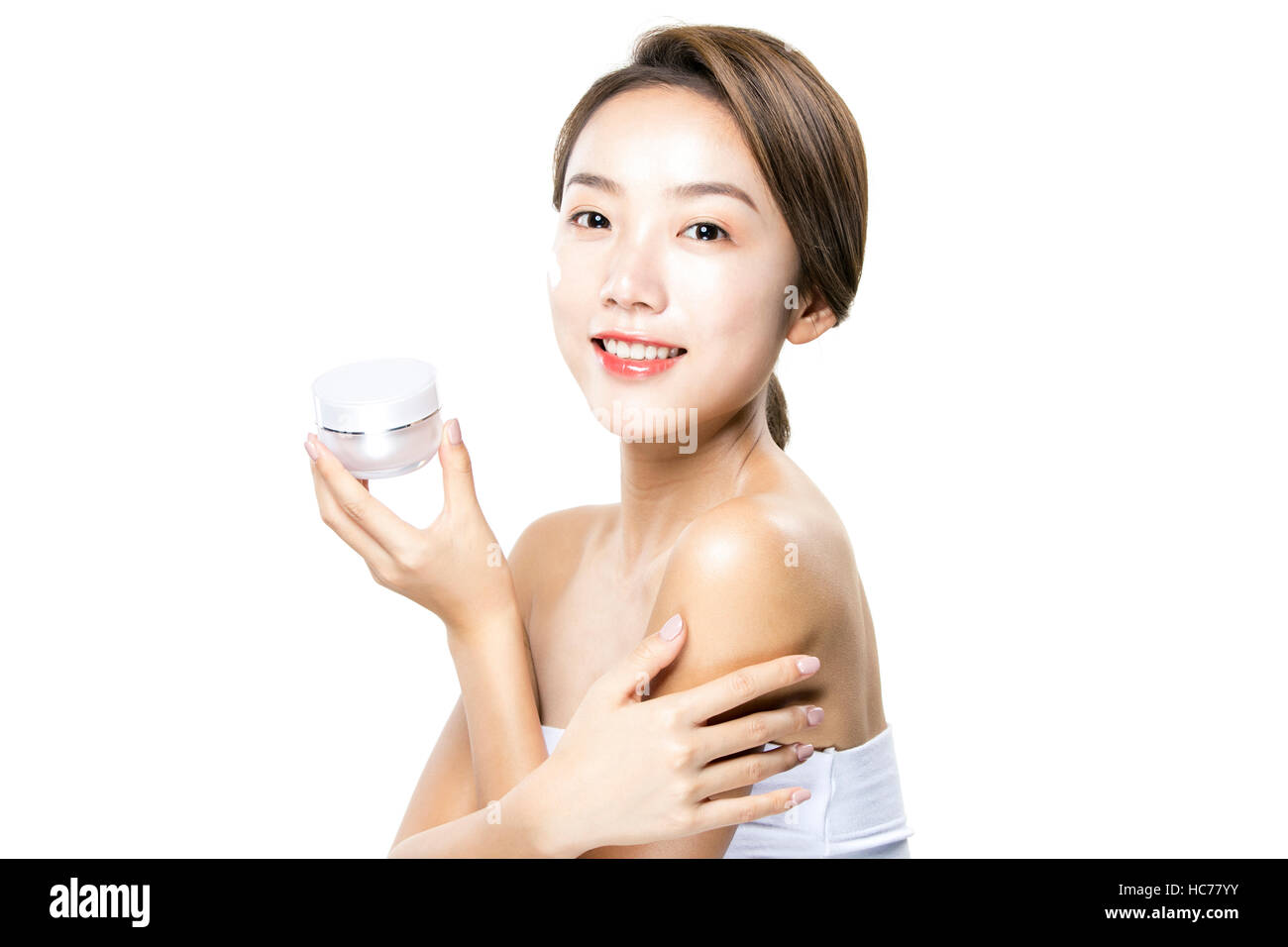 Smiling woman with cosmetic Banque D'Images