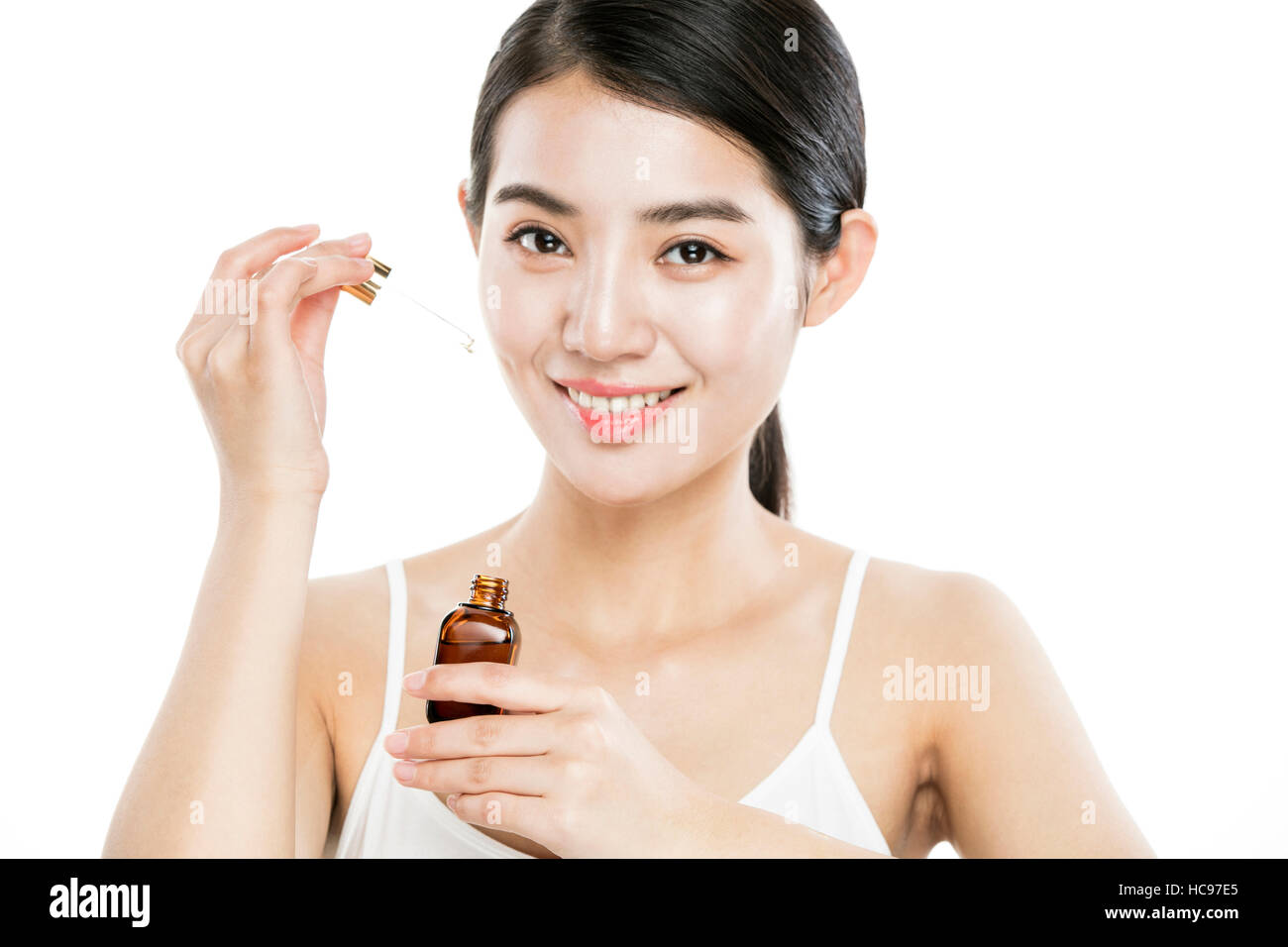 Portrait of young smiling woman with cosmetic Banque D'Images