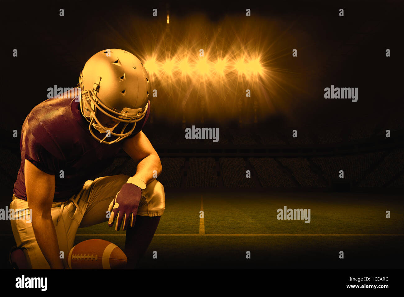 Image composite de joueur de football américain à genoux tout en maintenant le ballon Banque D'Images