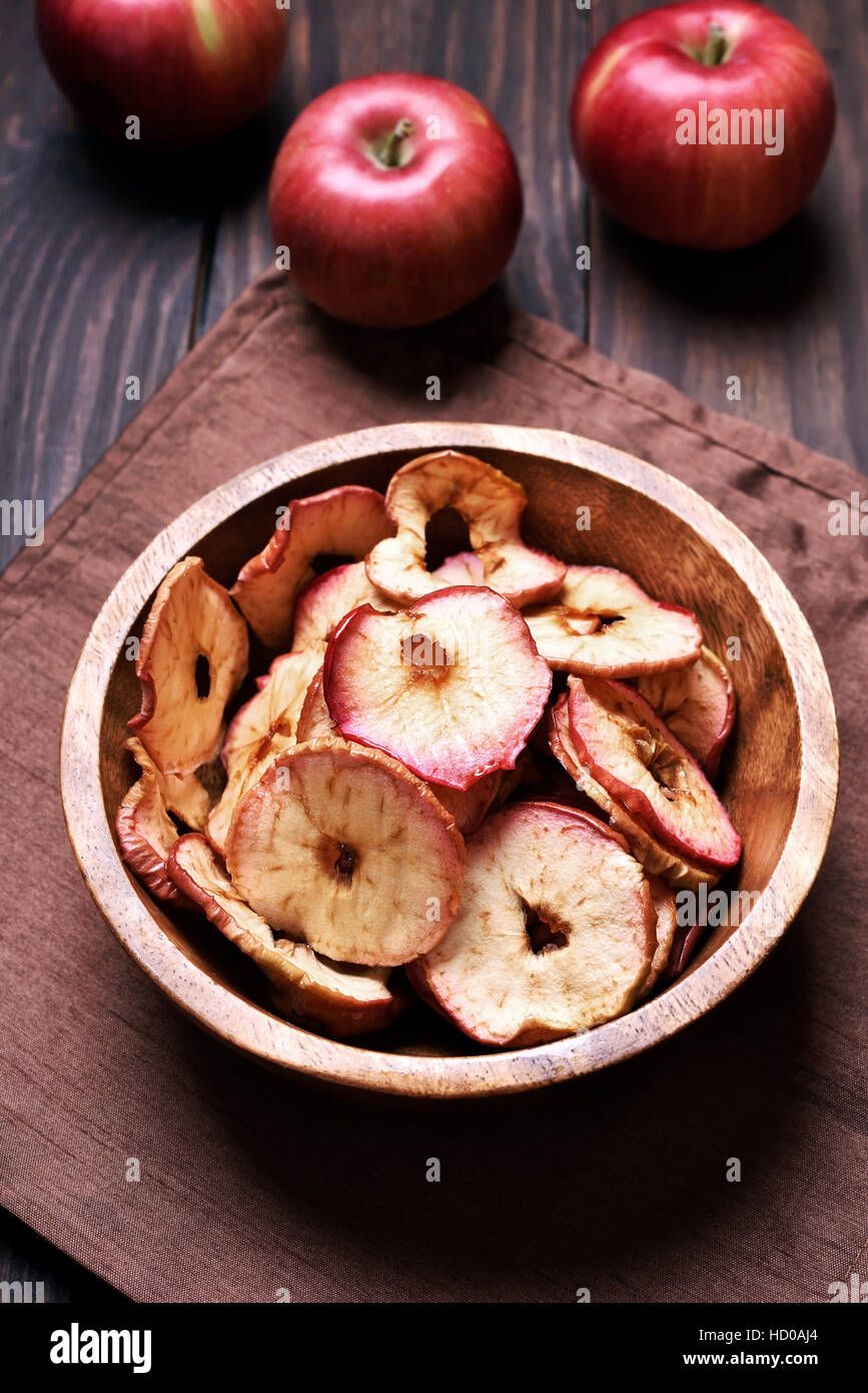 Pommes déshydratées jetons dans bol en bois, casse-croûte santé Banque D'Images