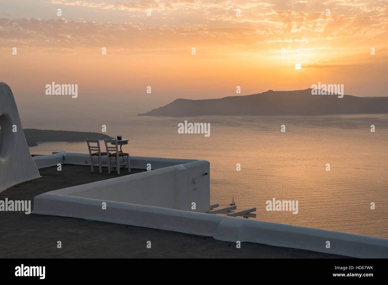Deux chaises sur terrasse, coucher de soleil, vue sur l'océan, Fira, Santorini, Cyclades, Grèce Banque D'Images