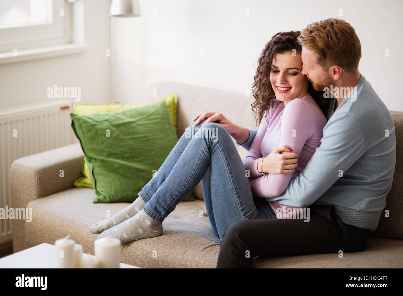 Couple in love hugging and smiling at home Banque D'Images