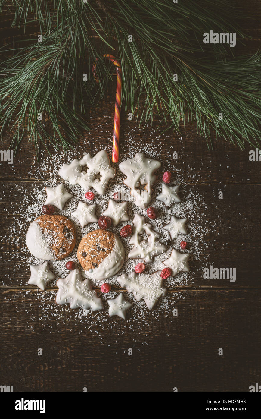 Boule de Noël faite par les cookies et les baies sur le fond de bois à la verticale Banque D'Images
