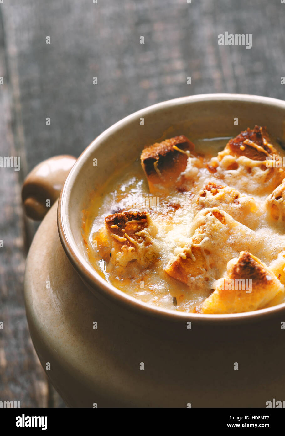 La soupe à l'oignon dans le pot en céramique à la verticale Banque D'Images