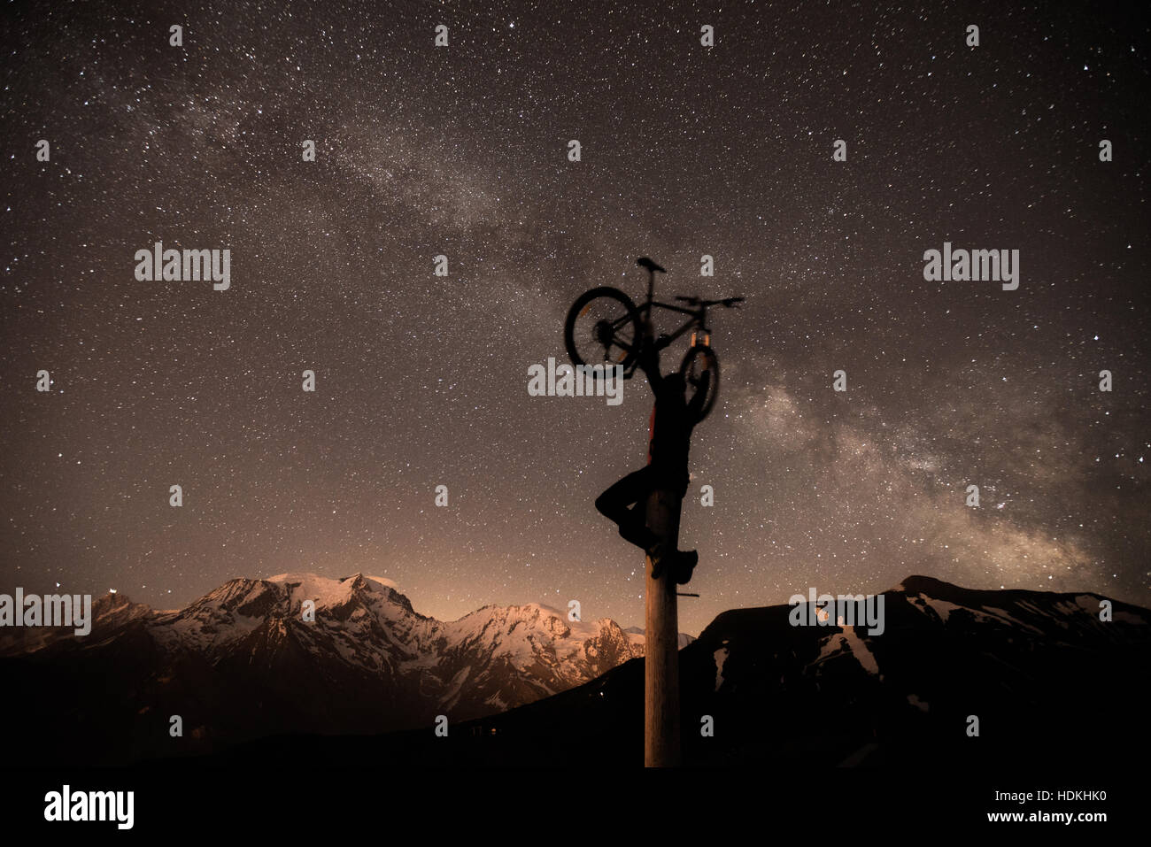 Voie lactée. Ciel de nuit avec des étoiles et silhouette d'un homme avec le vélo Banque D'Images