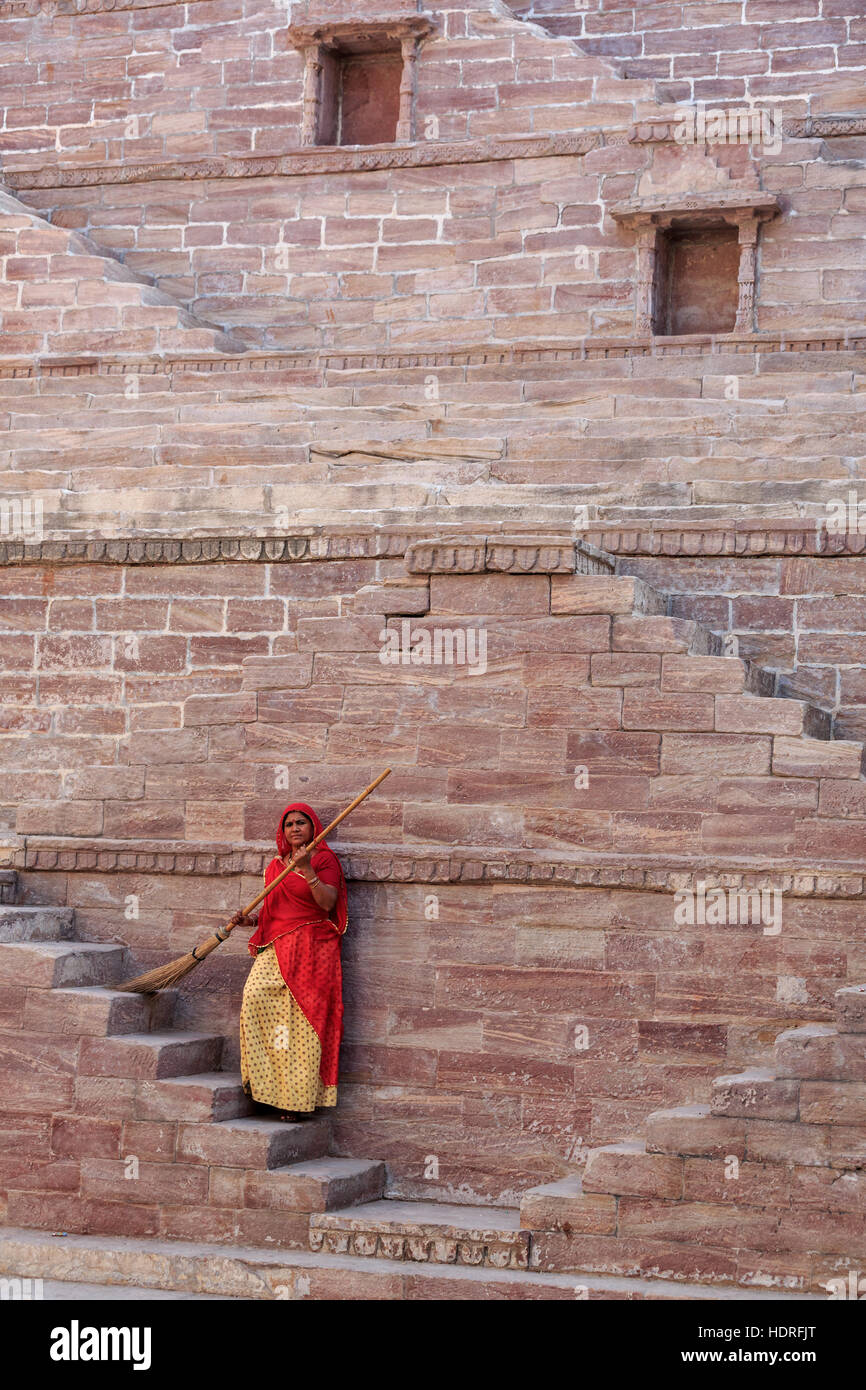 Femme en Sari les étapes de nettoyage à Toorji Jhalara Ka, l'étape et, Jodhpur, Rajasthan, India Banque D'Images