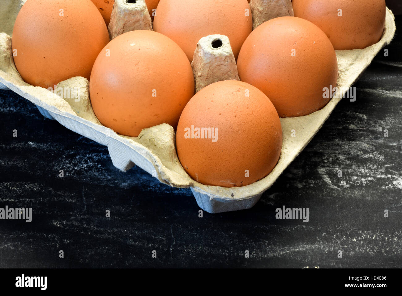 Les oeufs de poulet frais dans la case. Fond noir. Banque D'Images