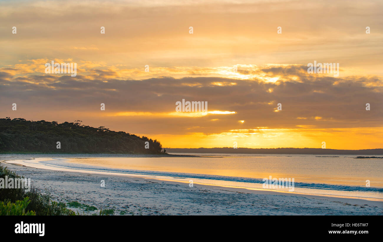 L'orange vif et jaune dans un lever de soleil sur Callala Bay sur la côte sud de la Nouvelle-Galles du Sud de l'Australie Banque D'Images