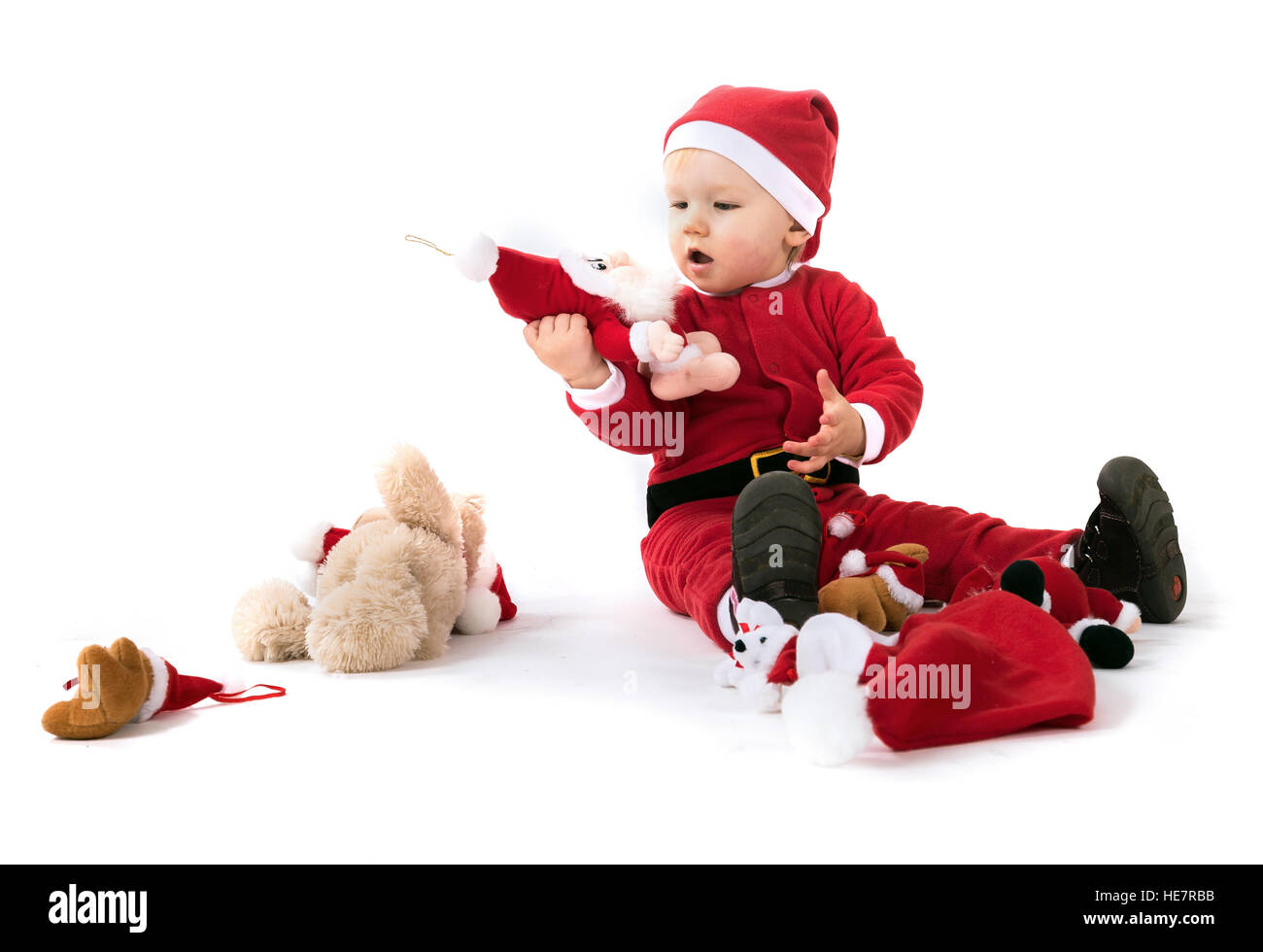 Portrait d'un enfant habillé comme le père Noël avec des jouets mous Banque D'Images