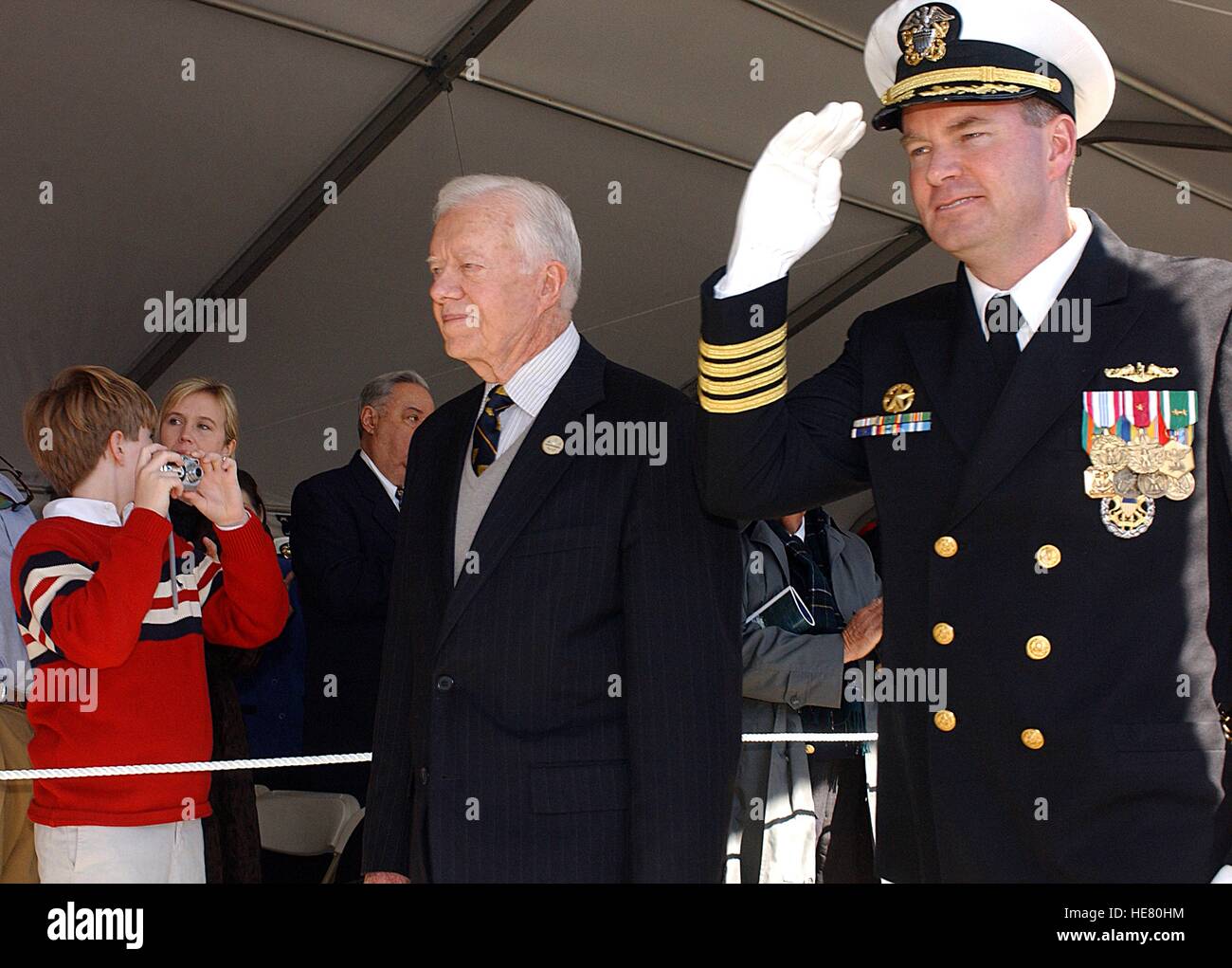 USN Commandant Robert Kelso escorts Jimmy Carter, ancien Président des États-Unis, passé une foule à la cérémonie de mise en service pour la marine américaine de la classe Seawolf-sous-marin d'attaque USS Jimmy Carter à la Naval Submarine Base New London, 19 février 2005 à Groton, Connecticut. Banque D'Images