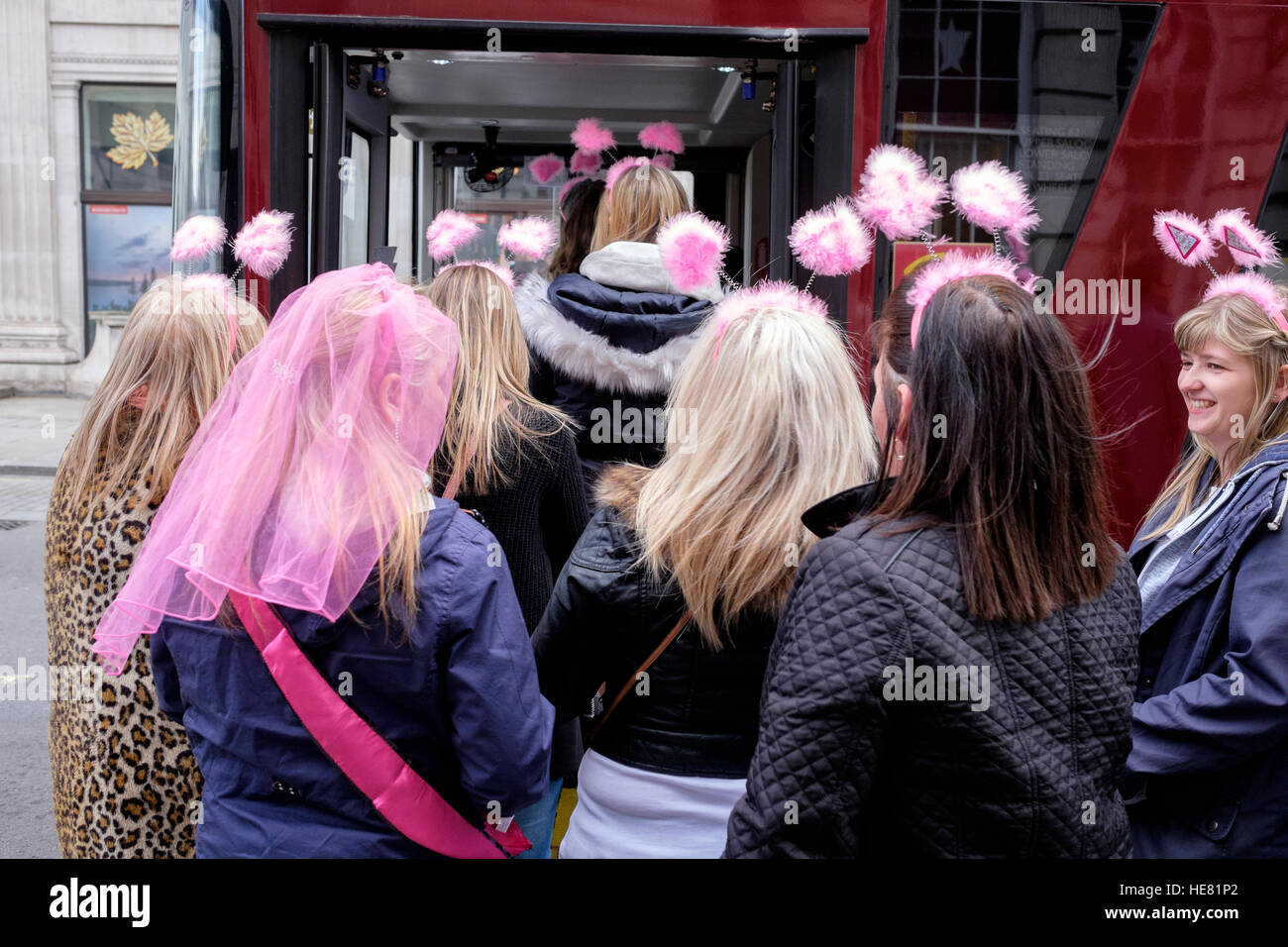 Mesdames portant des oreilles de lapin à poils sur une poule faire à Londres, Royaume-Uni Banque D'Images