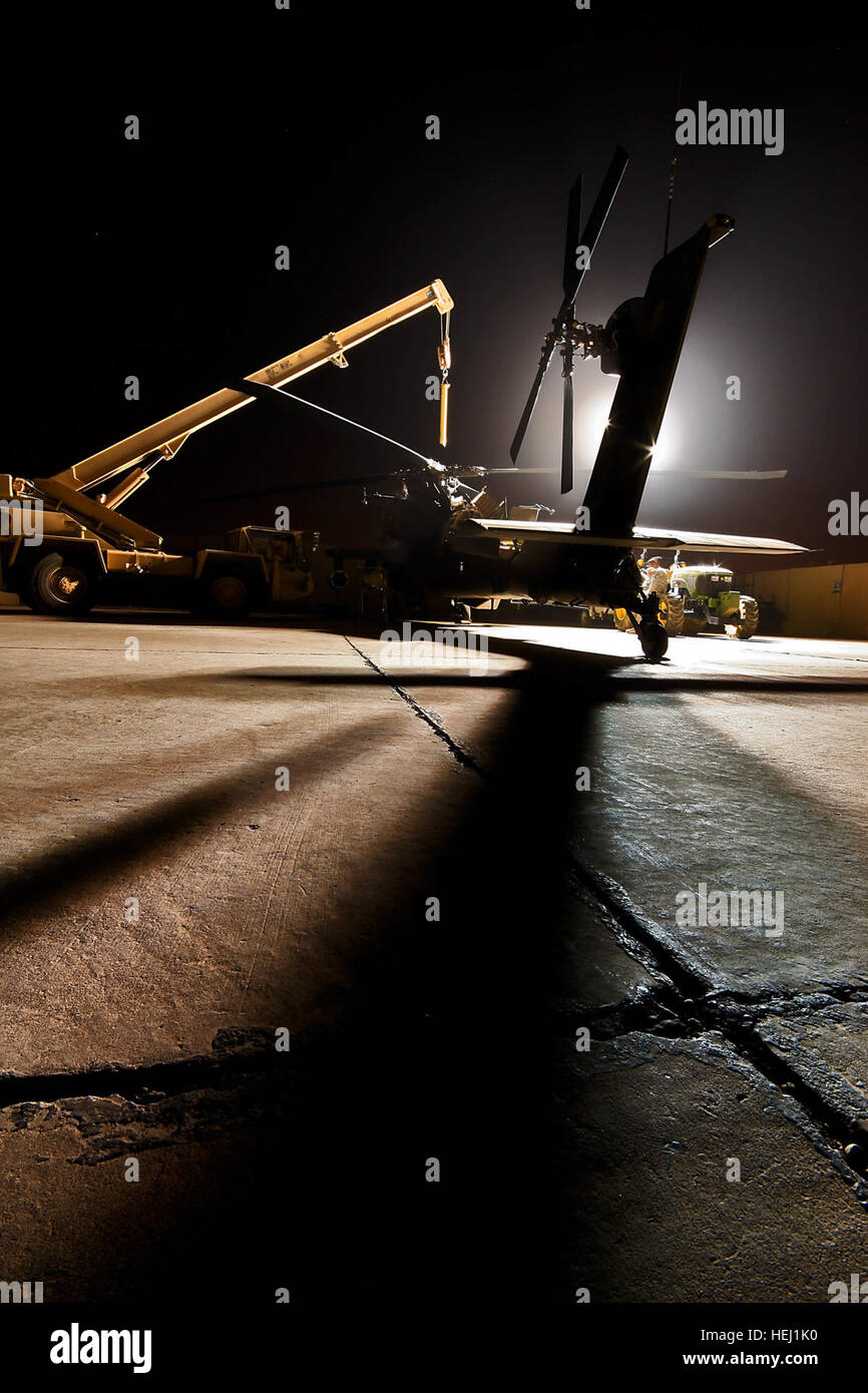 Travaillé toute la nuit sous les feux de l'utilitaire, AH-64D'équipage de l'hélicoptère d'attaque Apache chefs du 1er Bataillon, 227e Régiment d'aviation, 1st Air Cavalry Brigade, Division de cavalerie, Multi-National Division-Baghdad, apporter leur équipement à l'aéronef d'effectuer une tête de rotor principal les resserrer, ici, le 13 août. Pour la 1ère PBR, aviation opérations ont lieu autour de l'horloge - jour et nuit. Par la nuit de travail 195417 Banque D'Images