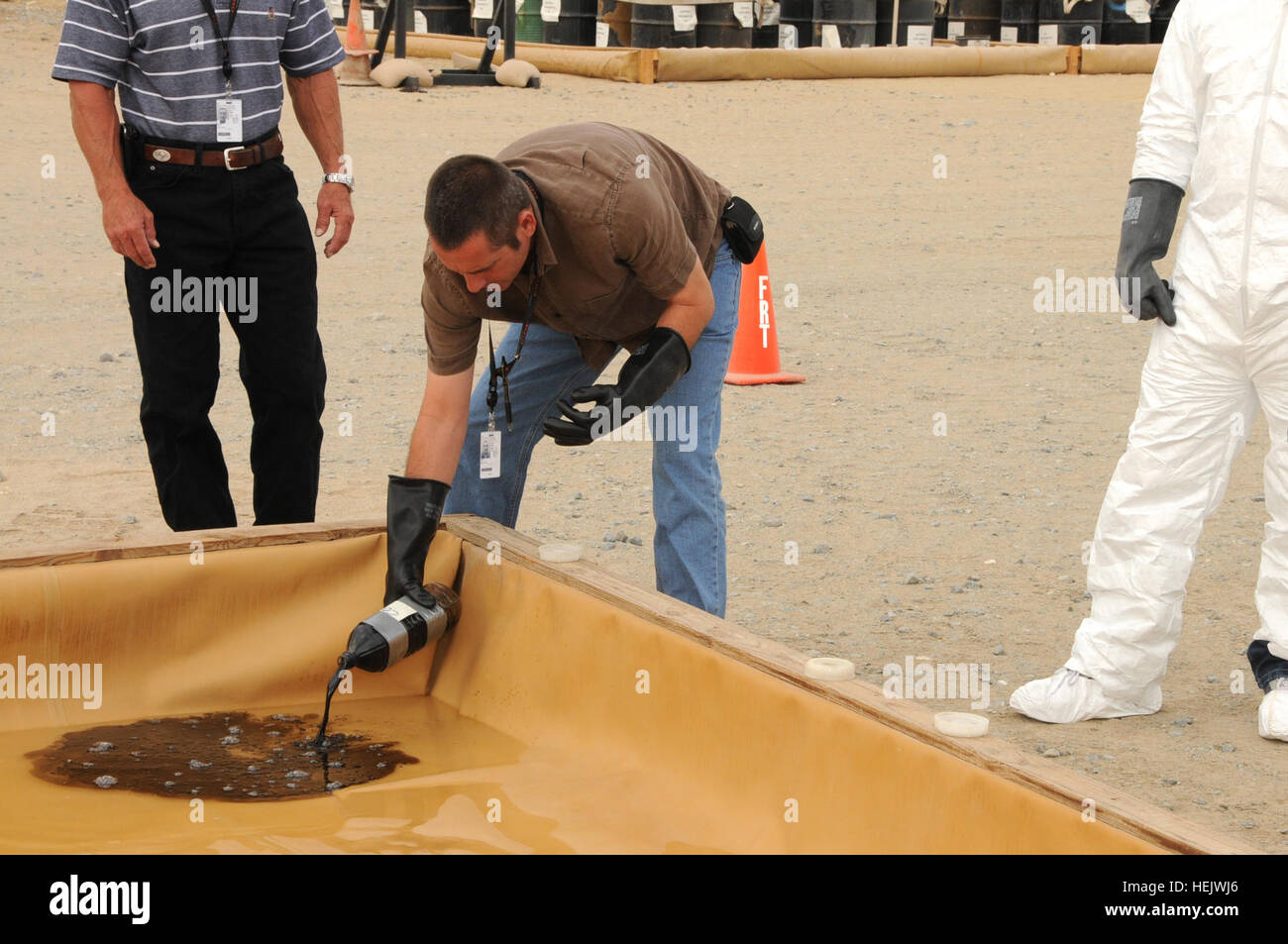 Kevin Meltzer, téléphone et télégraphe International entrepreneur Exelis/spill response leader et résident de Los Angeles, se déverse dans un matériau contaminé déversement dans l'eau dans le cadre d'un exercice pratique au cours de la fuite de carburant et d'intervention en cours en cliquant ici le 6 novembre. Les élèves répartis en équipes de trois et a utilisé des méthodes qu'ils ont appris au cours de l'enseignement en classe pour nettoyer le déversement simulé. Troisième armée est dédié à la protection de l'environnement au Koweït en informant les membres du service et des civils sur les procédures de nettoyage de déversements de matières dangereuses. Les membres du service, les civils apprennent à nettoyer l'huile, Banque D'Images