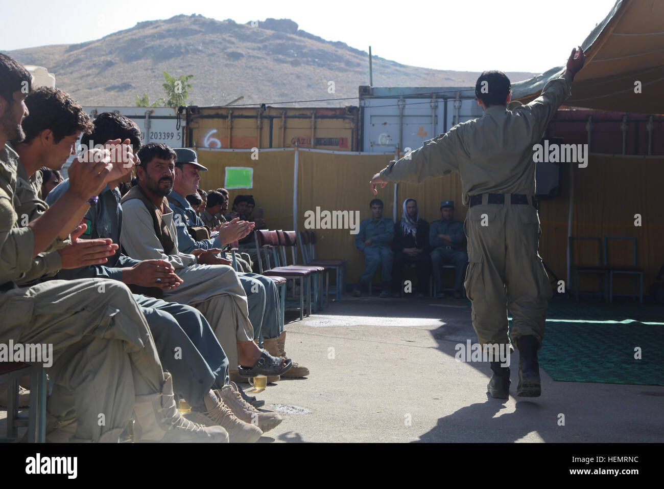 La police locale afghane (ALP) stagiaire à la musique dans les danses célébration de remise des diplômes, Ghazni, district de la province de Ghazni, Afghanistan, le 26 septembre 2013. L'ALP 57 stagiaires préparé pour le jour de la remise des diplômes au centre de formation de la province de Ghazni après une longue semaine trois plomb afghan ALP programme qui porte sur le développement professionnel, les techniques médicales, petite unité tactique, et de compétences d'armes. (U.S. Photo de l'armée par la CPS. Jessica Reyna DeBooy/libérés) Se préparer pour l'obtention du diplôme 130926-A-SL739-010 Banque D'Images