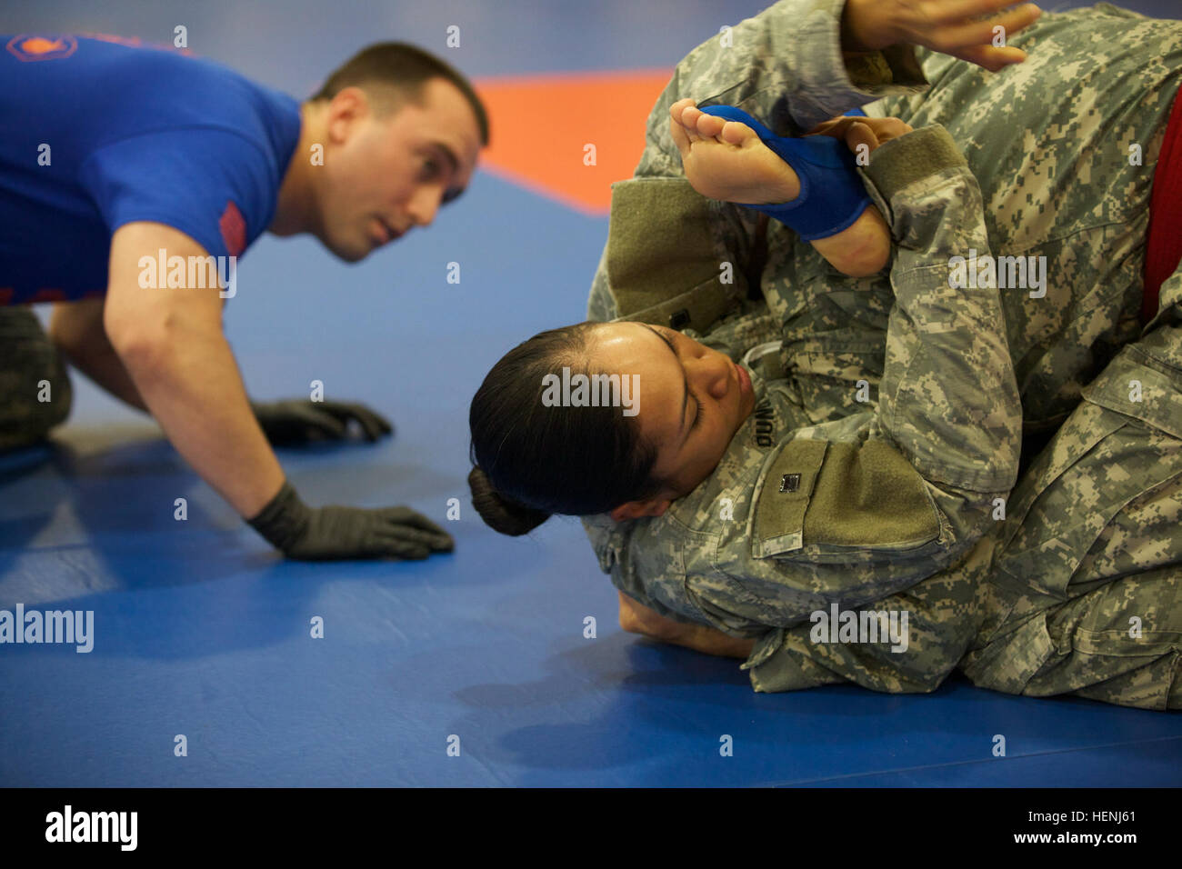 Deux soldats de l'armée américaine se battre entre eux, tout en étant observés par un arbitre pendant un tournoi combatives de l'armée à Fort Dix, N.J., le 8 juin 2014. Ce tournoi comprend des soldats, aviateurs et marins, en compétition dans différentes catégories de poids pour une chance de gagner le titre. (U.S. Photo de l'armée par le Sgt. Austin Berner/libérés) 98e tournoi de la Division Army Combatives 140608-A-BZ540-022 Banque D'Images