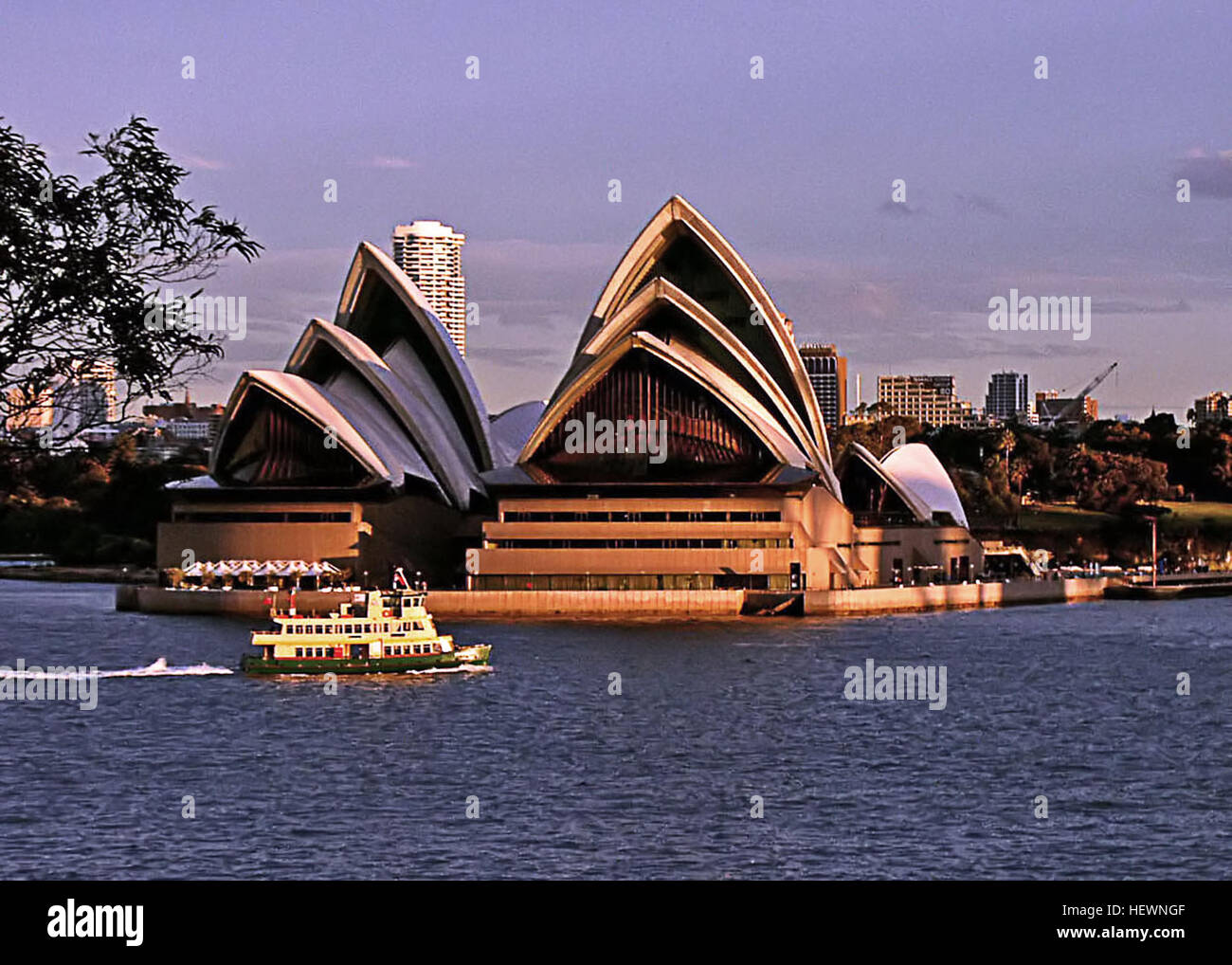 Une vue de l'Opéra de Sydney avec ses voiles blanches emblématiques reflétées dans les eaux de Bennelong point, Sydney, Australie. Connu pour son architecture expressionniste, c'est un lieu culturel et des arts de la scène de renommée mondiale. Banque D'Images