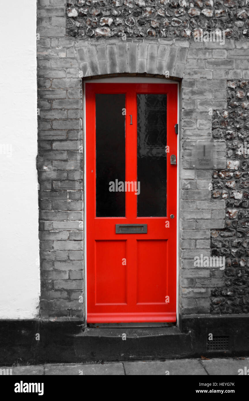 La porte rouge sur noir et blanc façade. Banque D'Images