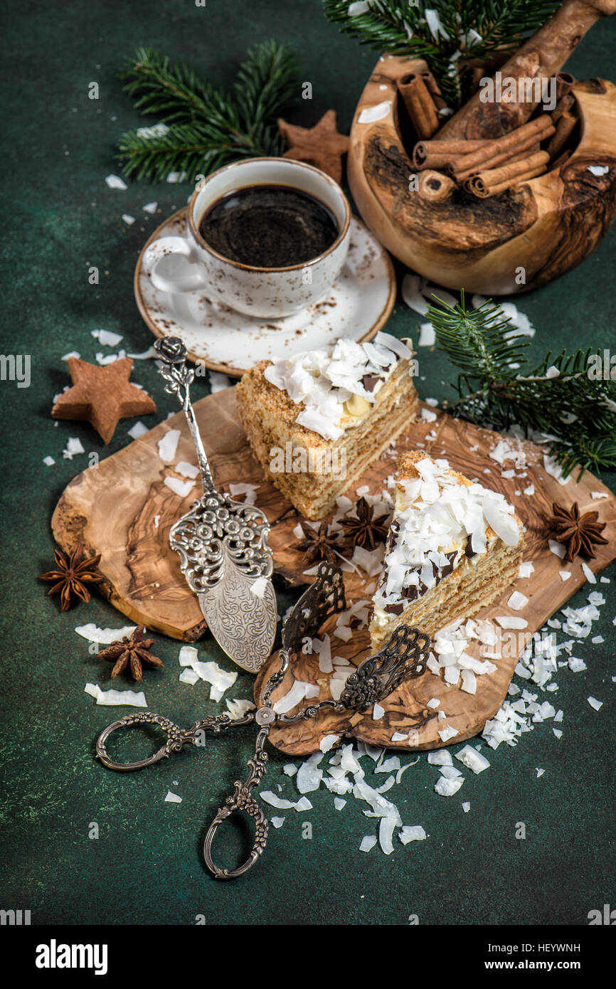 Gâteau au miel avec décoration de Noël et de tasse de café sur fond sombre. Douce Fête de la nourriture. Tons style vintage photo Banque D'Images