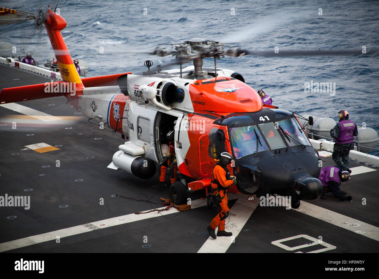 Une garde côtière des États-Unis d'hélicoptères HH-60J Jayhawk reçoit le carburant de Marines américains et de marins avec l'Escadron amphibie 3 et la 15e unité expéditionnaire de marines à bord du navire d'assaut amphibie USS Peleliu (LHA 5) au large de la côte sud de la Californie le 4 juin 2012. L'hélicoptère a reçu de carburant pour remplir une mission de l'évacuation d'un civil mariner dans le besoin de soins médicaux d'un hôpital de San Diego. (U.S. Marine Corps photo prise par le sergent d'artillerie. John A. Lee II) marines, les marins de la Garde côtière canadienne aide à l'évacuation des 120604-M-TF338-048 Banque D'Images