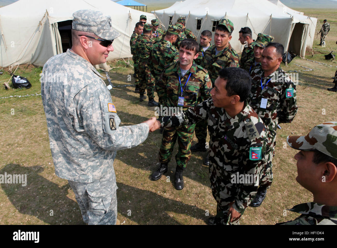 Le capitaine de l'armée népalaise Janardan Gurung (droite), instructeur à l'Centre de formation aux opérations de paix, Birendra Népal, se présente au 1er Sgt. Jeff Alberts, fellow 'sapper' et supérieurs de l'armée américaine enrôle représentant au cours de KHAAN QUEST, août 4. Environ 1 000 militaires de 13 pays différents participent à KHAAN QUEST 2013 en Mongolie, qui se compose d'un exercice de poste de commandement (XPC) et de terrain (FTX) à cinq Hills Domaine de formation, à la fois l'accent sur le maintien de la paix et de la stabilité des opérations. Mongol et forces armées des États-Unis, avec d'autres partenaires régionaux, w Banque D'Images