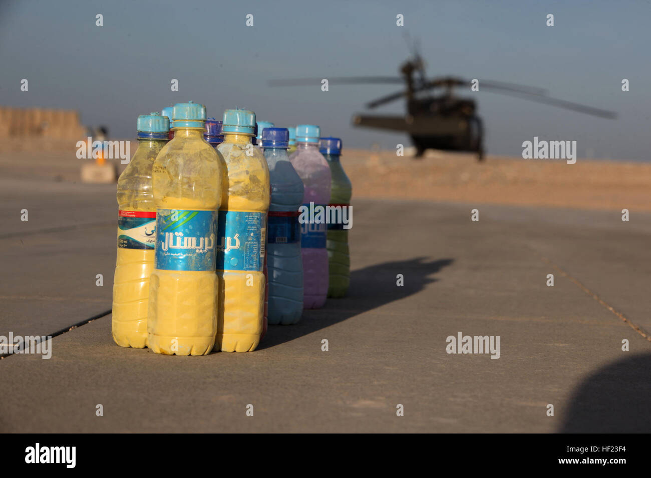 Des bouteilles remplies d'eau la fécule colorés sont placés près de l'aire d'atterrissage des hélicoptères d'évacuation médicale et de 1 kilomètres de tour de passage pour le 'Splash' Dustoff Dash 5K à bord le Camp Bastion, l'Afghanistan, le 19 avril 2014. L'escadron d'évacuation médicale connue sous le nom de "ustoff» a organisé une course de 5 km pour les militaires à bord de Bastion et Camps Sapadalure pour apporter un peu de plaisir et de soulagement du stress pour les forces de coalition du Commandement régional (Sud-ouest). Les participants ont été encouragés à s'habiller en costumes et accessoires pour l'exécuter et sortir à établir de bons rapports. L'USMC (Photo : Sgt. Frances Johnson/Re Banque D'Images