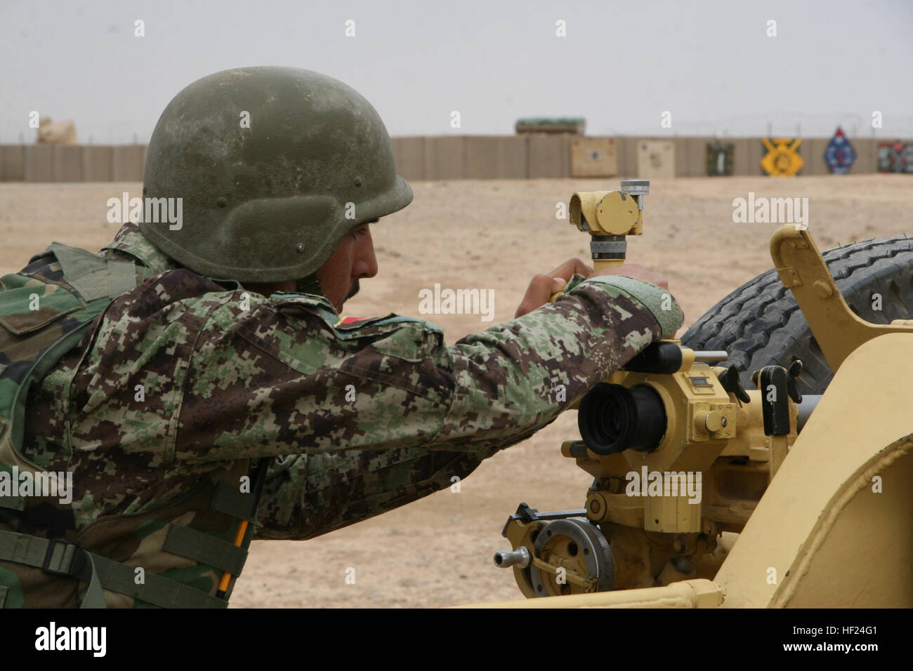 Un soldat de l'Armée nationale afghane avec le 215e Corps soigneusement les réglages afin d'LE D-30 obusier de 122 mm pendant la formation à bord le Camp Bastion, dans la province d'Helmand, en Afghanistan, le 7 mai 2014. La formation fait partie d'un cours de six semaines a enseigné à l'École de combat du Corps régional qui donne les instructeurs afghans la possibilité de former leurs collègues soldats sur l'obusier système d'armes. Les trains régionaux École de combat de corps de soldats de l'Armée nationale afghane sur l'obusier d'exploitation 140507-M-KC435-008 Banque D'Images