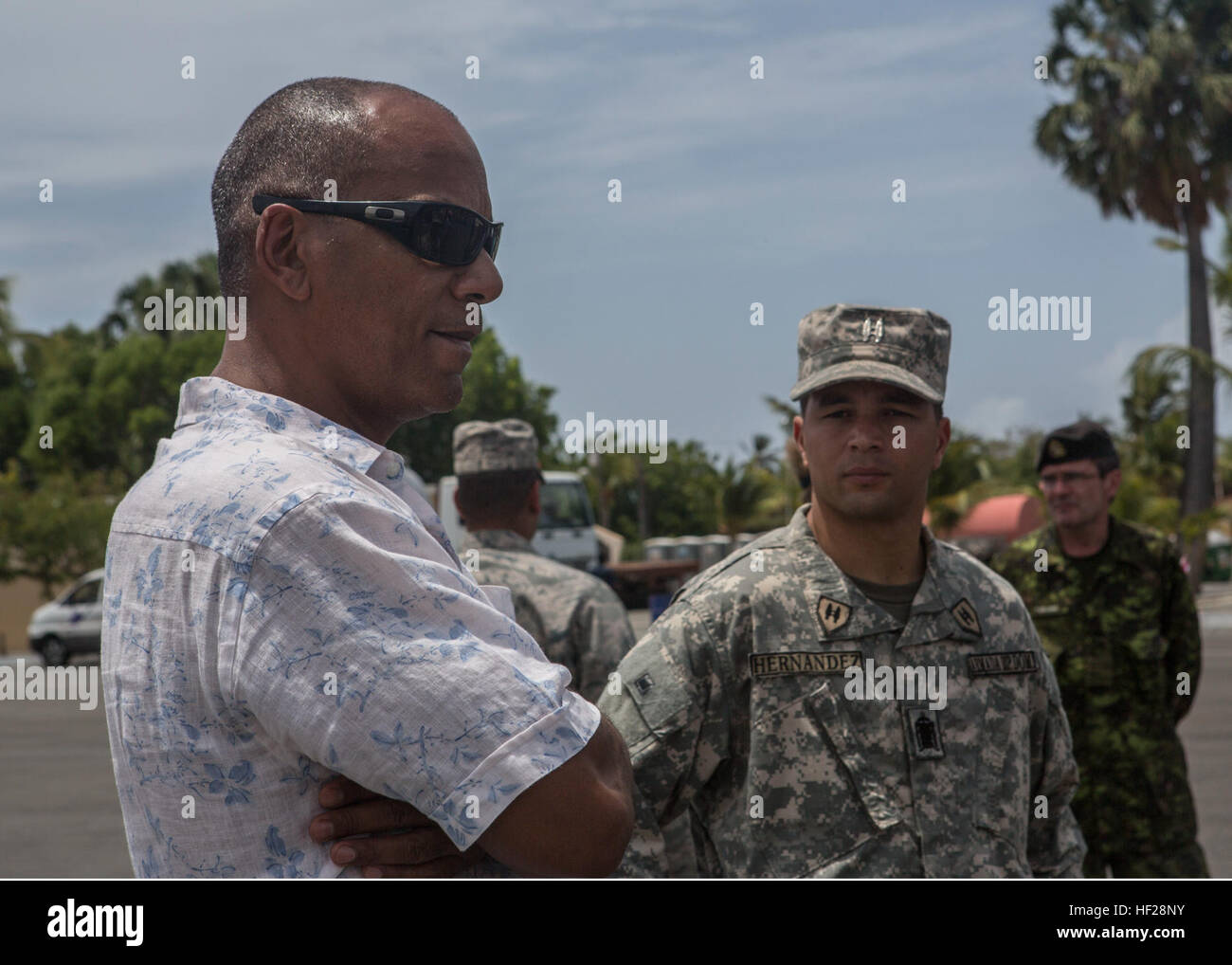 Moses Alou, ancien joueur canadien de basket-ball, parle avec des officiers de l'US Marines avec Charley, 4e compagnie du bataillon de l'application de la loi maritime, Réserve des Forces canadiennes, et sur les 13 pays partenaires qui sont stationnés à bord de la base navale de République Dominicaine, Las Calderas situé près de Bani, République dominicaine au cours de l'exercice Tradewinds 2014, le 21 juin 2014. L'ambassadeur Brewster a visité la base navale et a eu l'occasion d'observer une partie de la formation évolutions intervenant dans le cadre de la phase II de l'exercice. La Phase II de Tradewinds 2014 est surtout un exercice d'entraînement sur le terrain de masse qui s'est tenue du 16 juin Banque D'Images